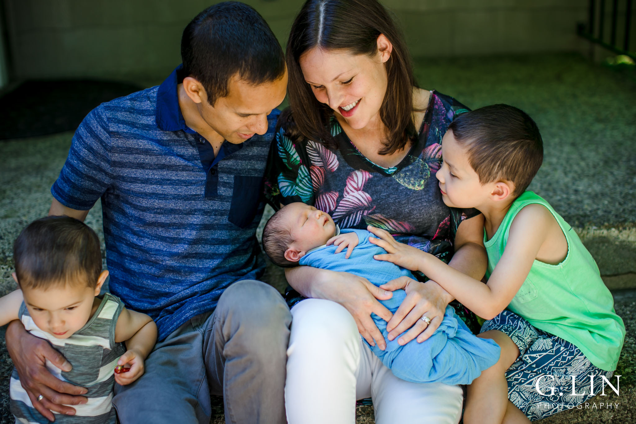 Raleigh Family Photographer | G. Lin Photography | Family outside of home and looking at baby