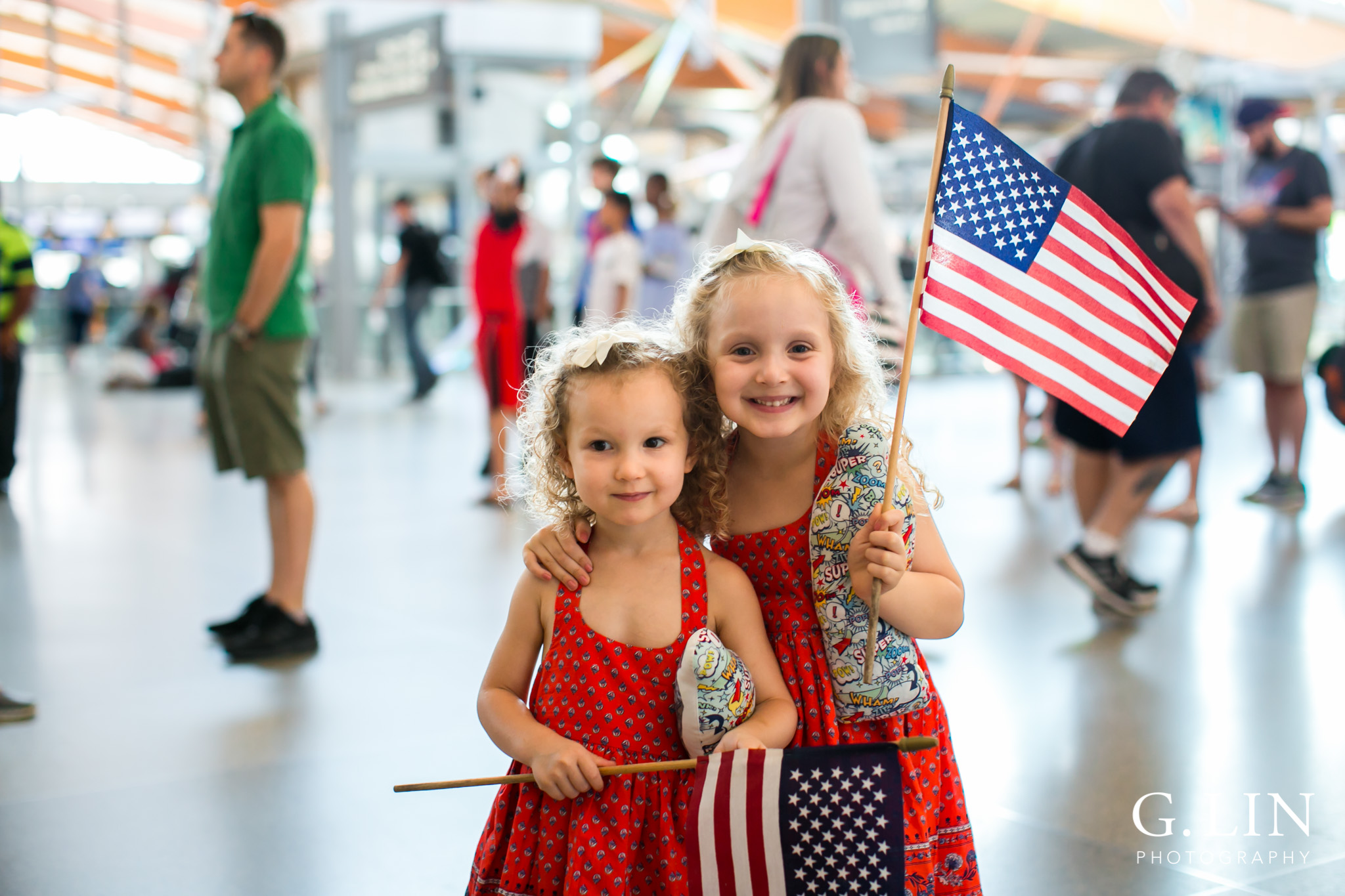 Raleigh Family Photographer | G. Lin Photography | Little girls smiling at camera and holding flag