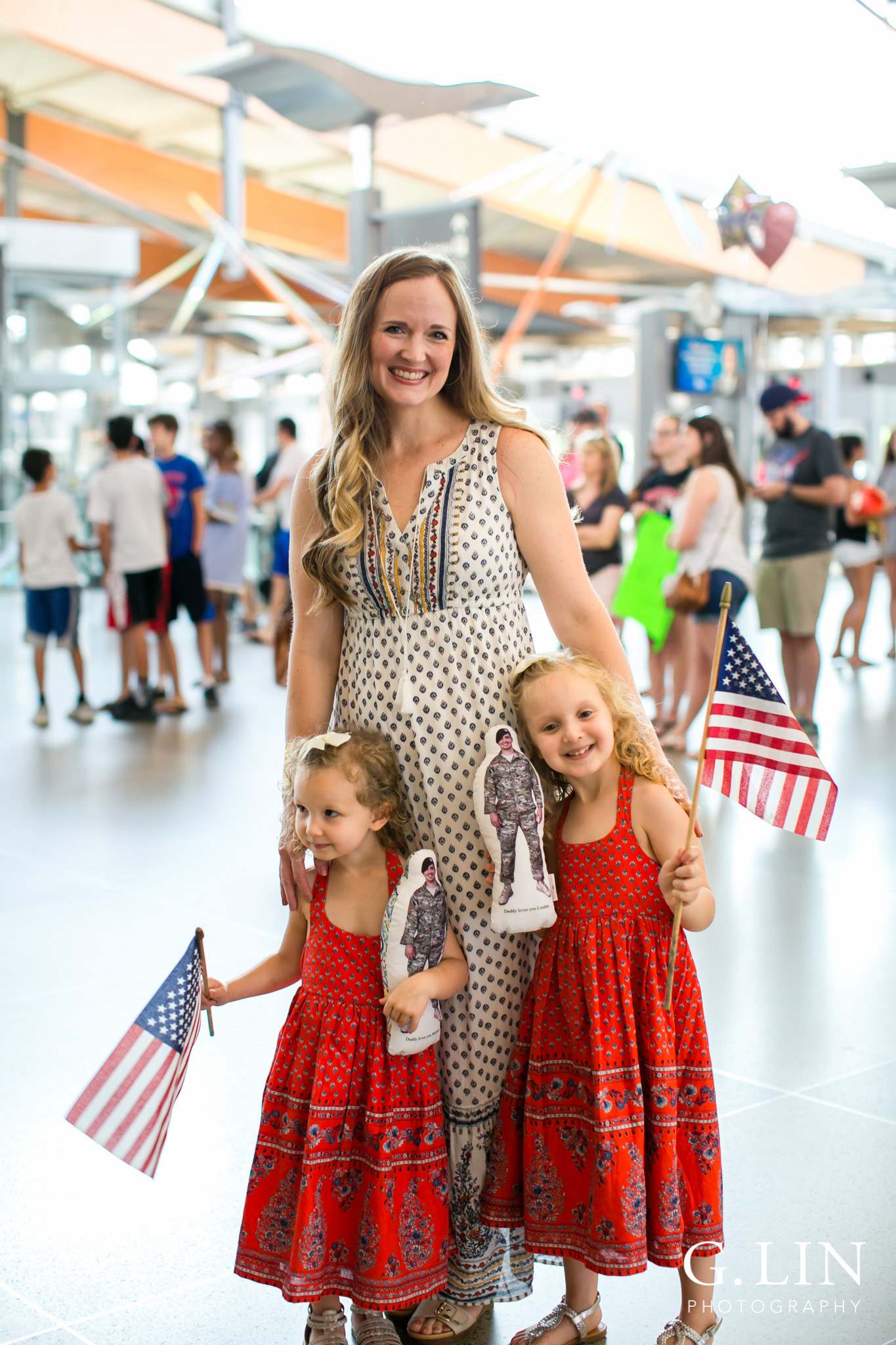 Raleigh Family Photographer | G. Lin Photography | Little girls with their mom smiling and standing in the airport