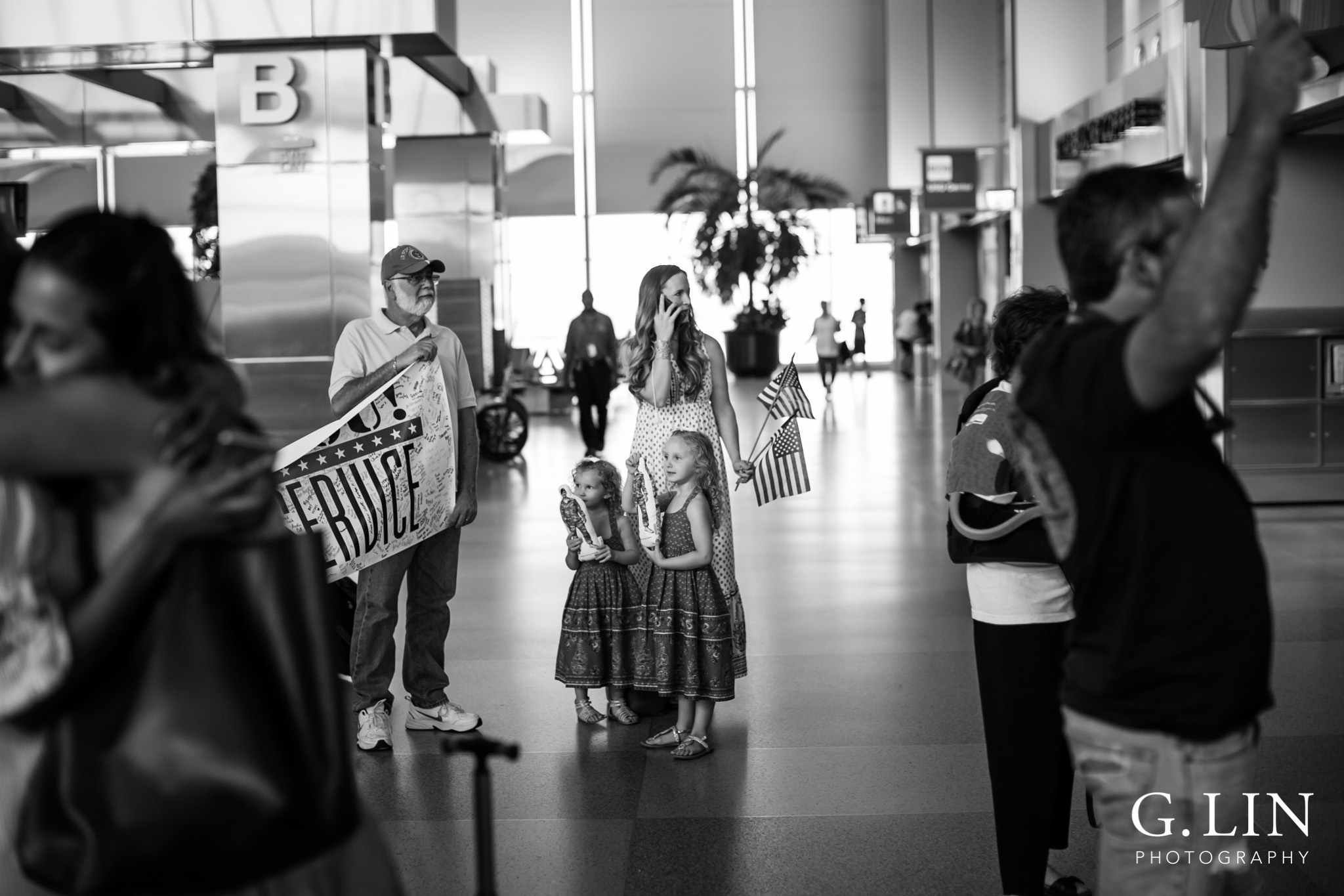 Raleigh Family Photographer | G. Lin Photography | wife on the phone waiting for husband at airport