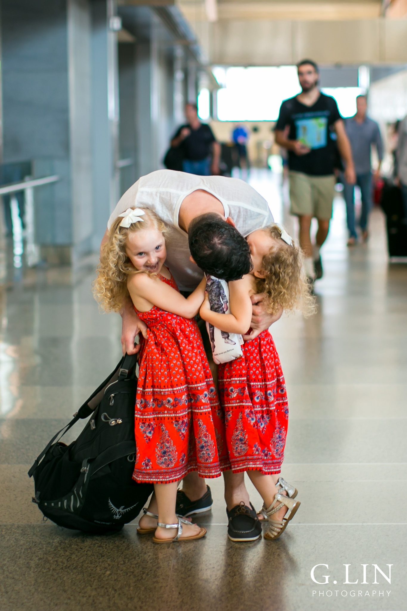 Raleigh Family Photographer | G. Lin Photography | two girls hugging their dad and welcoming him home