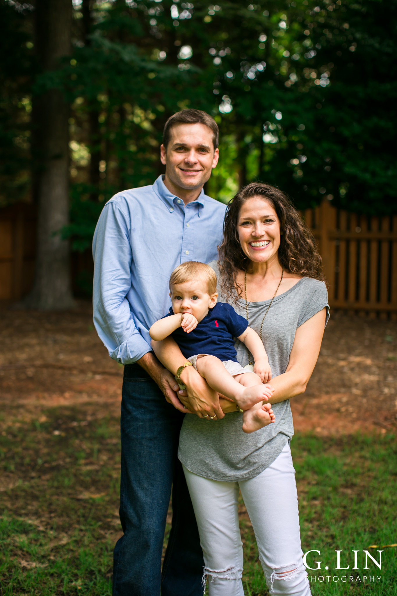 Raleigh Family Photographer | G. Lin Photography | Family of three smiling at camera in garden
