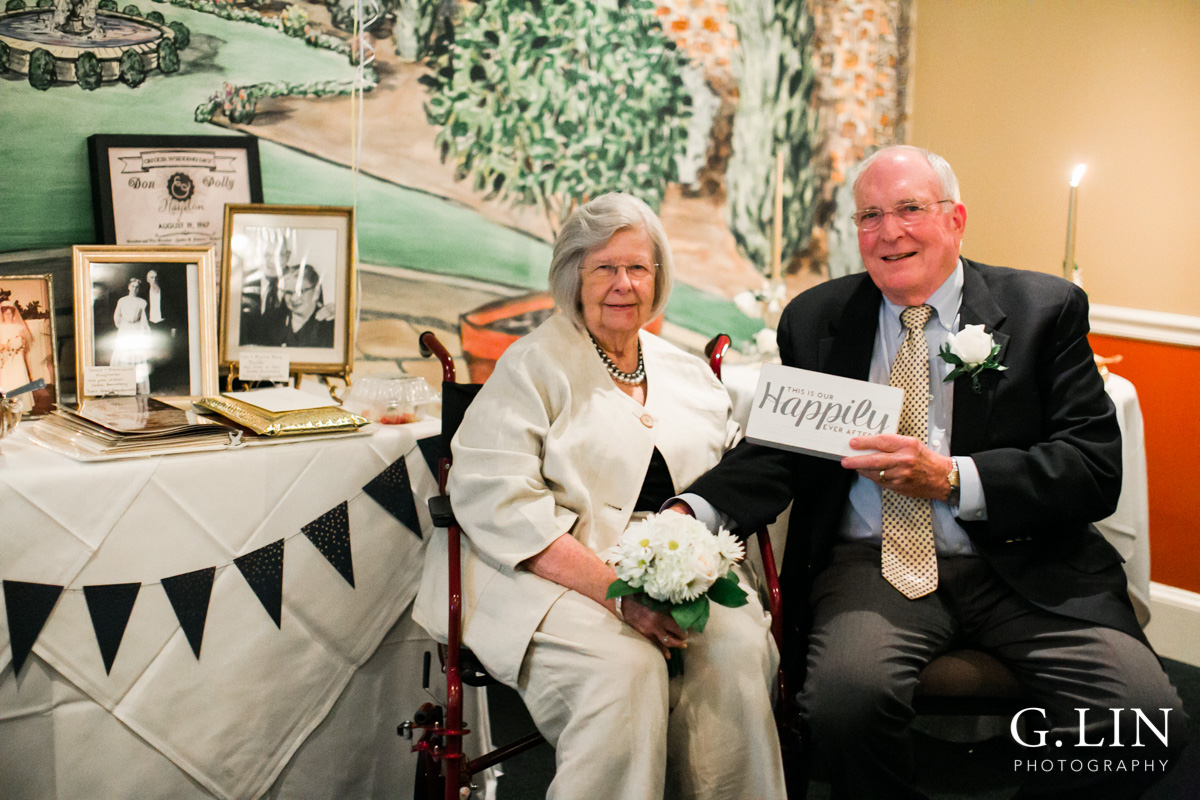 Raleigh Family Photographer | G. Lin Photography | Couple smiling at camera and holding wedding sign