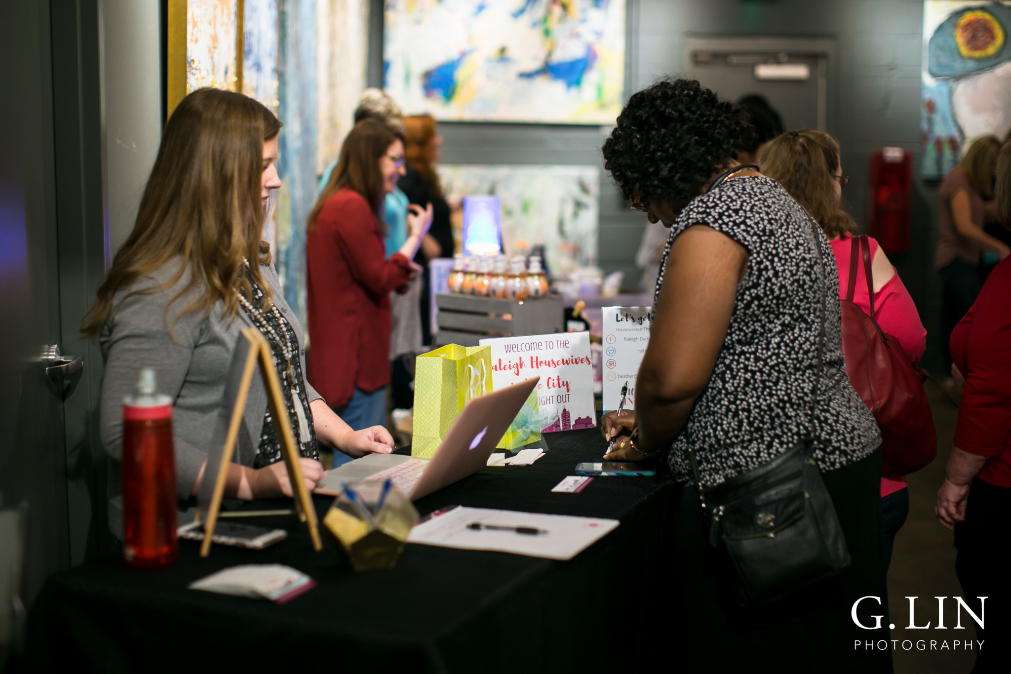 Raleigh Event Photographer | G. Lin Photography | Woman checking in guests at door entrance