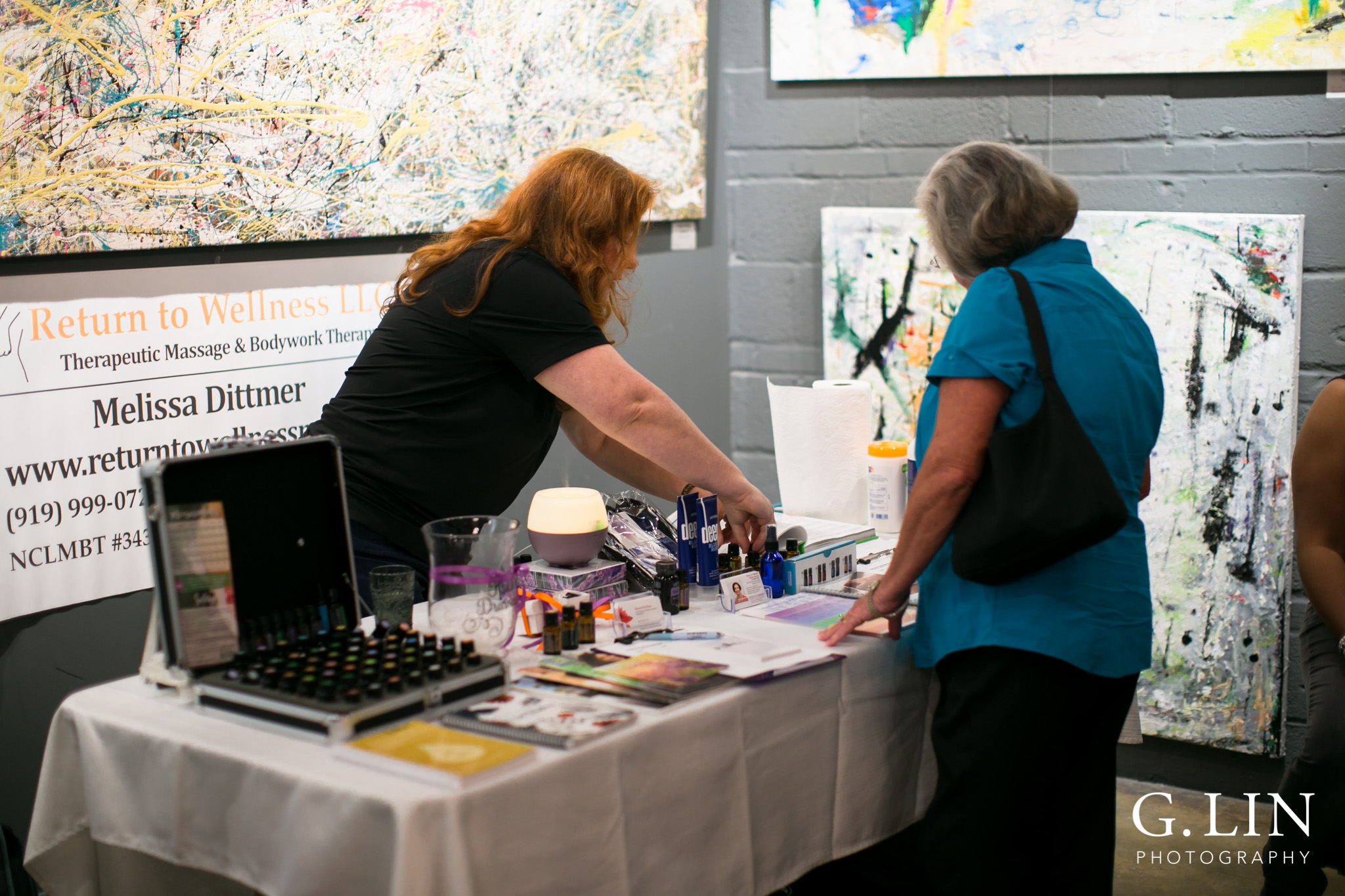 Raleigh Event Photographer | G. Lin Photography | Vendor showing customer items on table