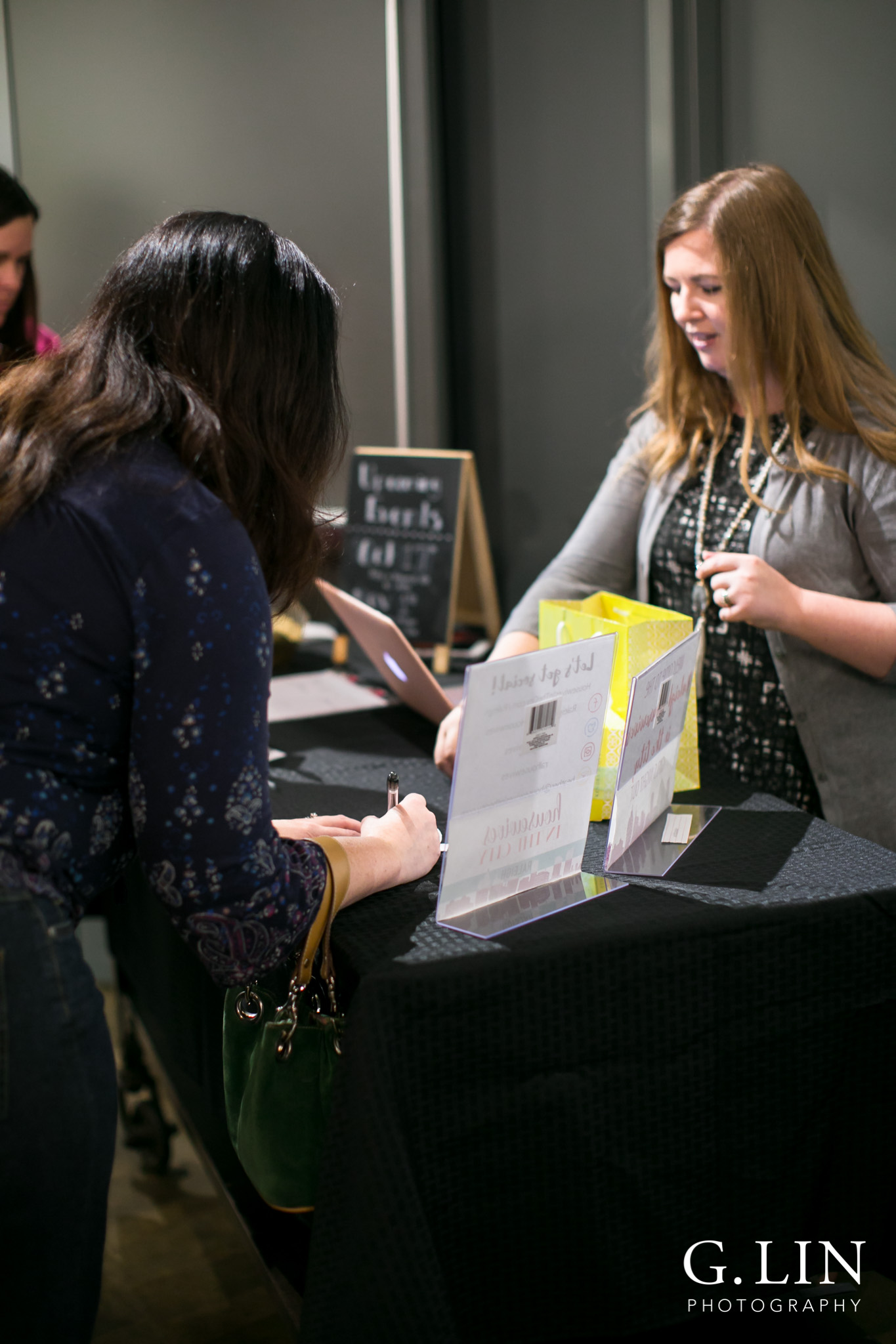 Raleigh Event Photographer | G. Lin Photography | Woman signing in at registration table