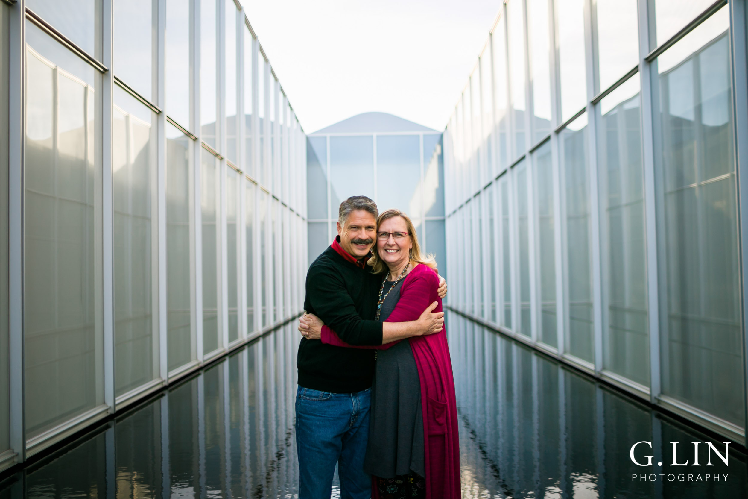 Raleigh Family Photographer | G. Lin Photography | Couple hugging each other at NCMA