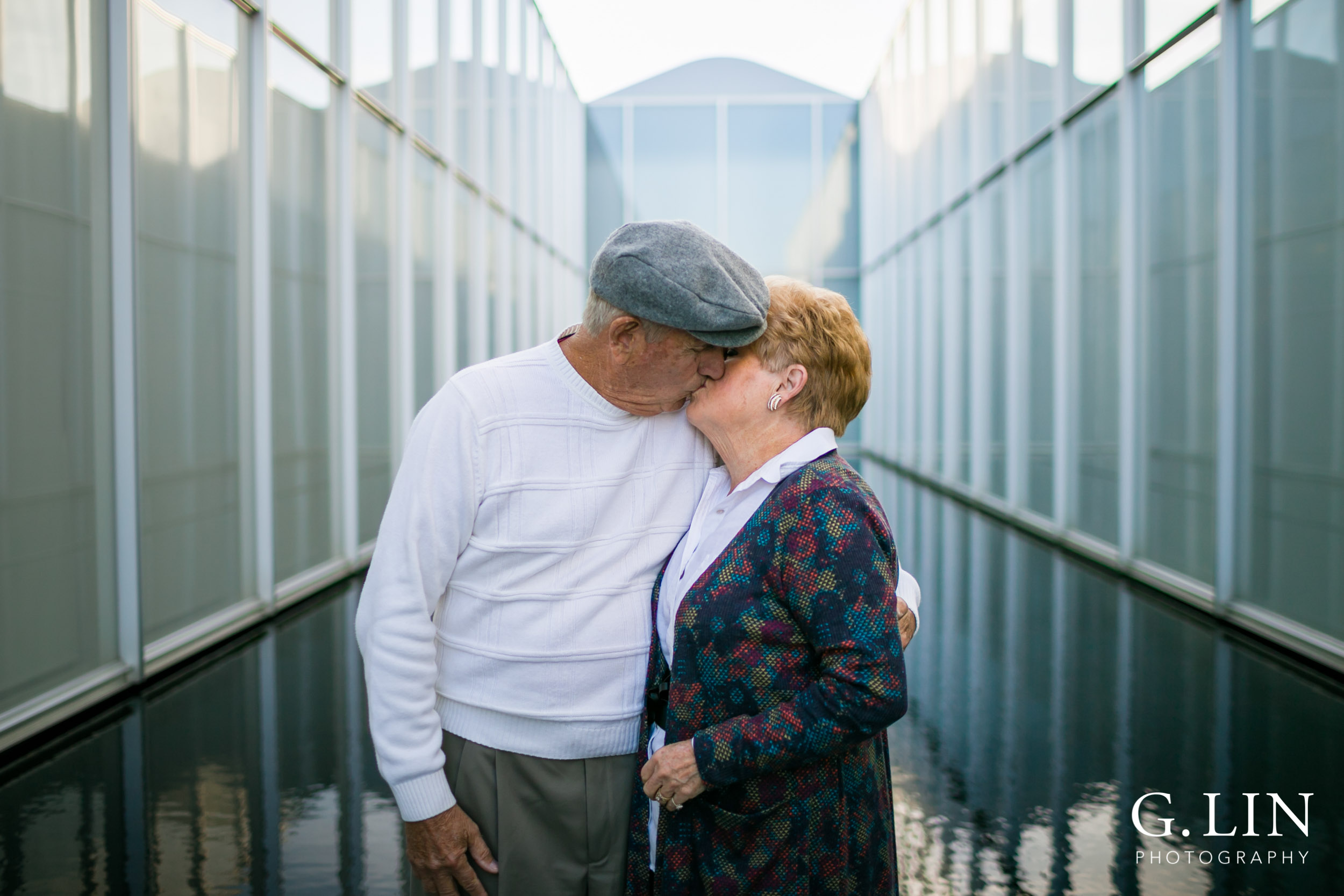 Raleigh Family Photographer | G. Lin Photography | Husband and wife kissing at NC Museum of Art