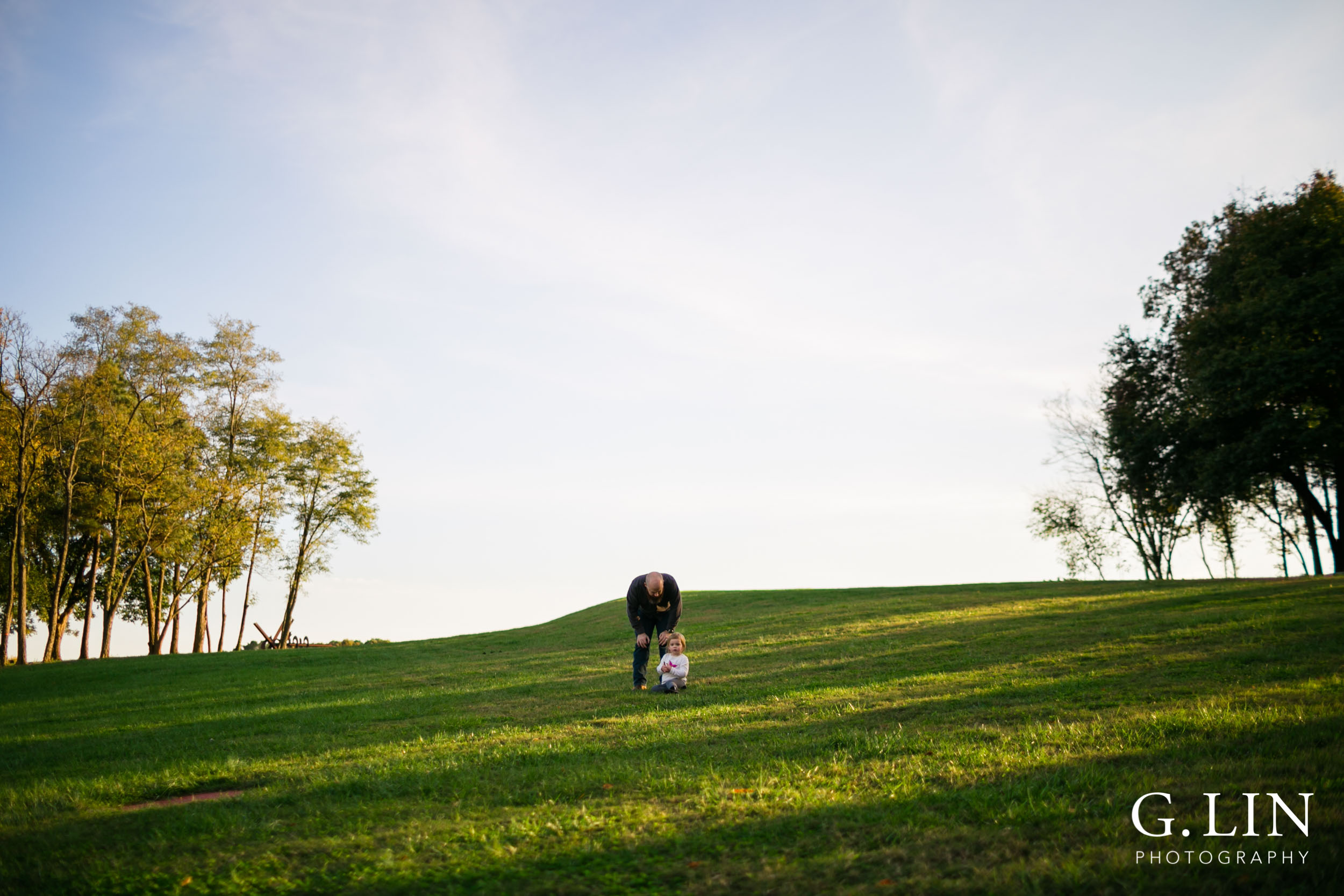 Raleigh Family Photographer | G. Lin Photography | Dad talking to daughter in the field