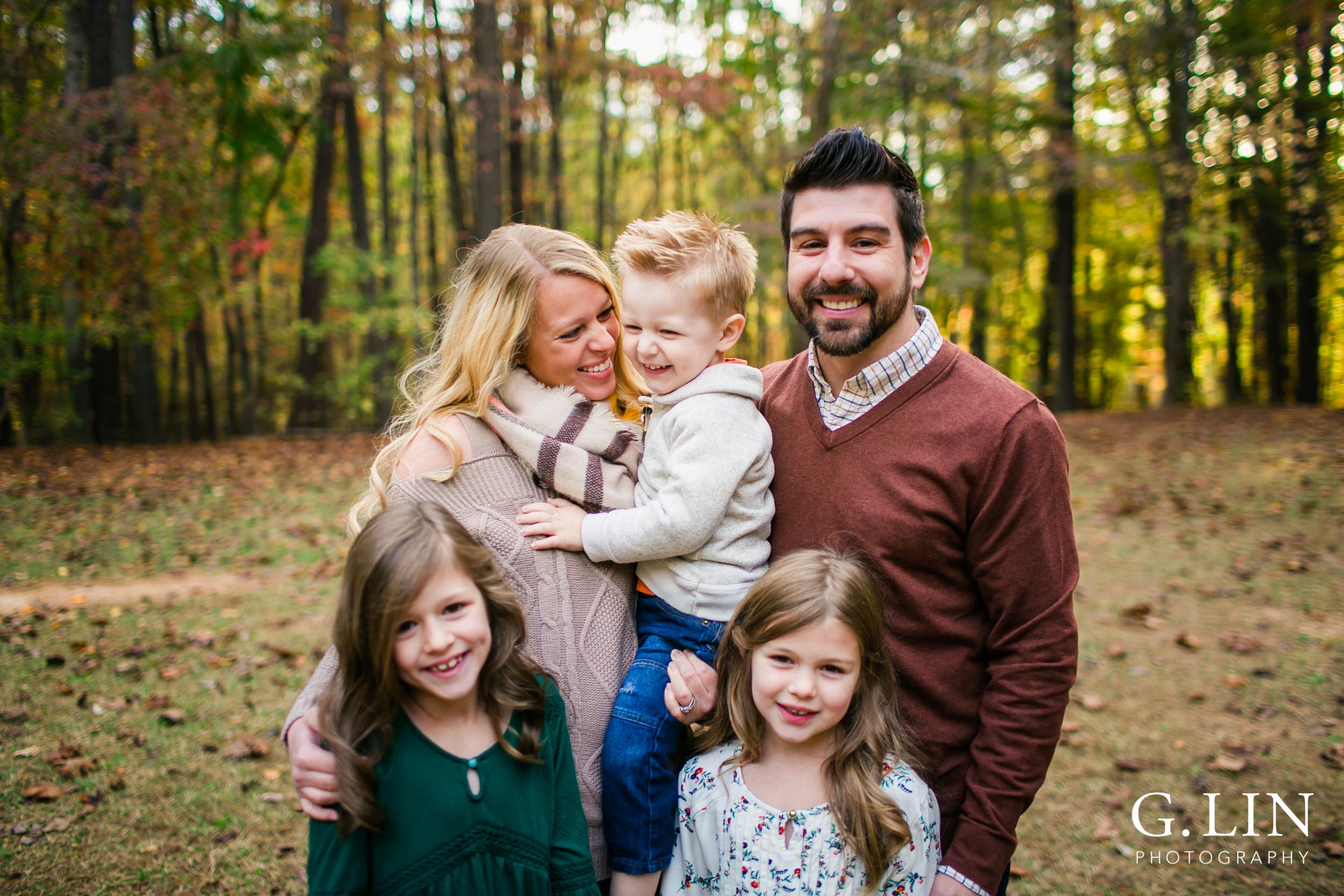 Raleigh Family Photographer | G. Lin Photography | Candid photo of family looking at each other at the park