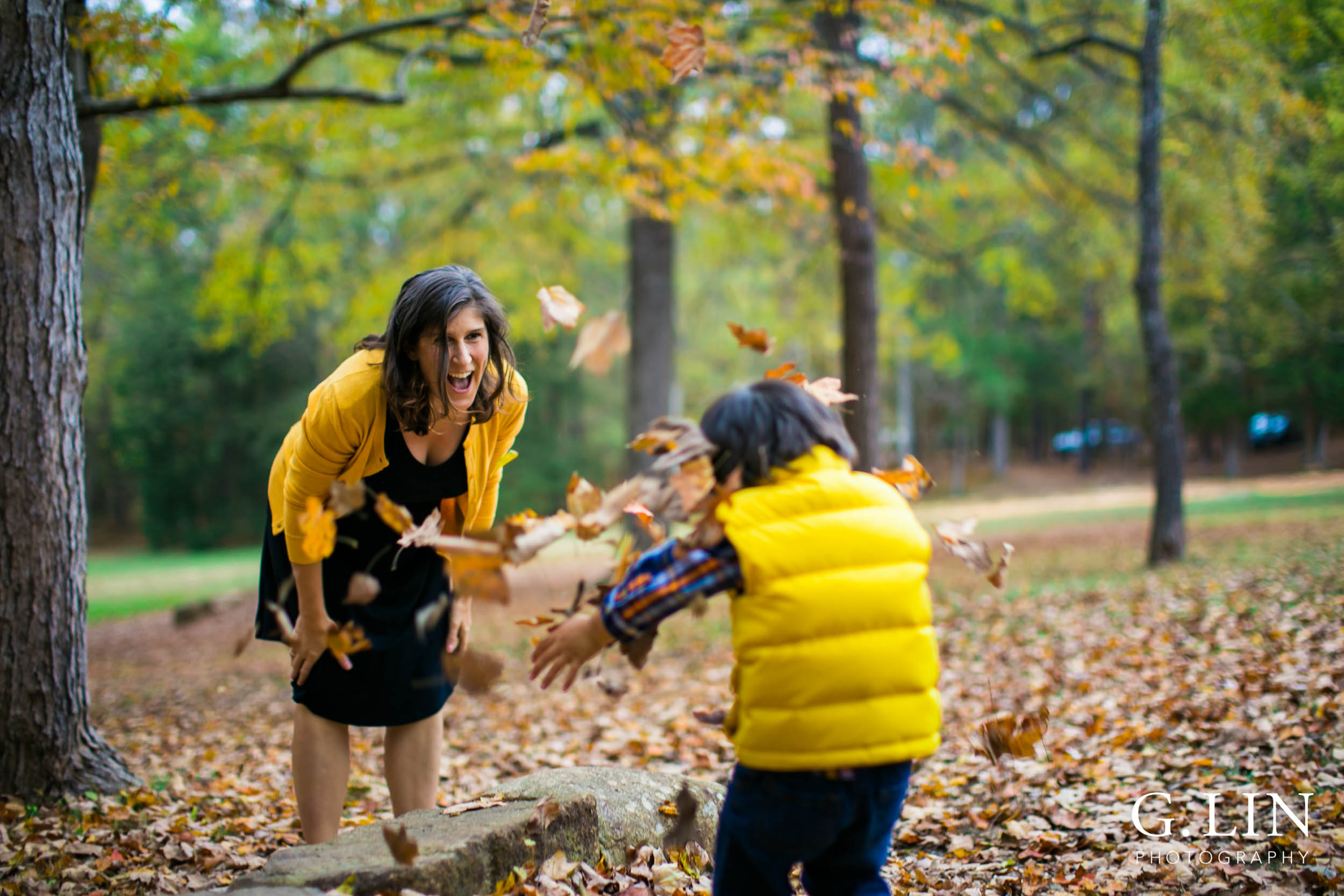 Durham Family Photography | G. Lin Photography | Mother and son playing with fall leaves