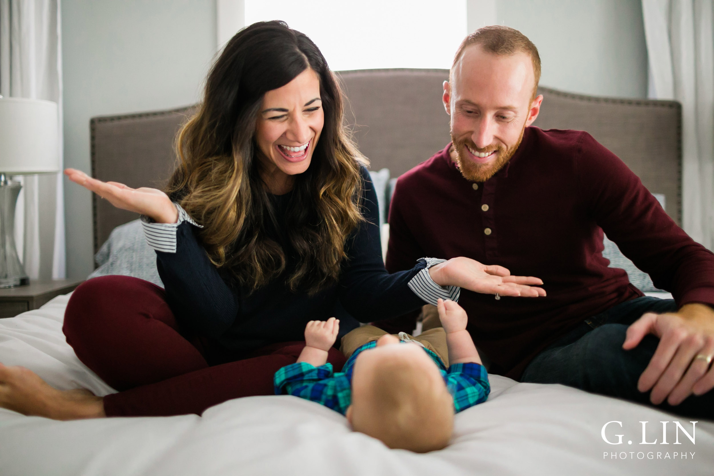 Durham Family Photographer | G. Lin Photography | Mom playing peekaboo with baby boy on bed