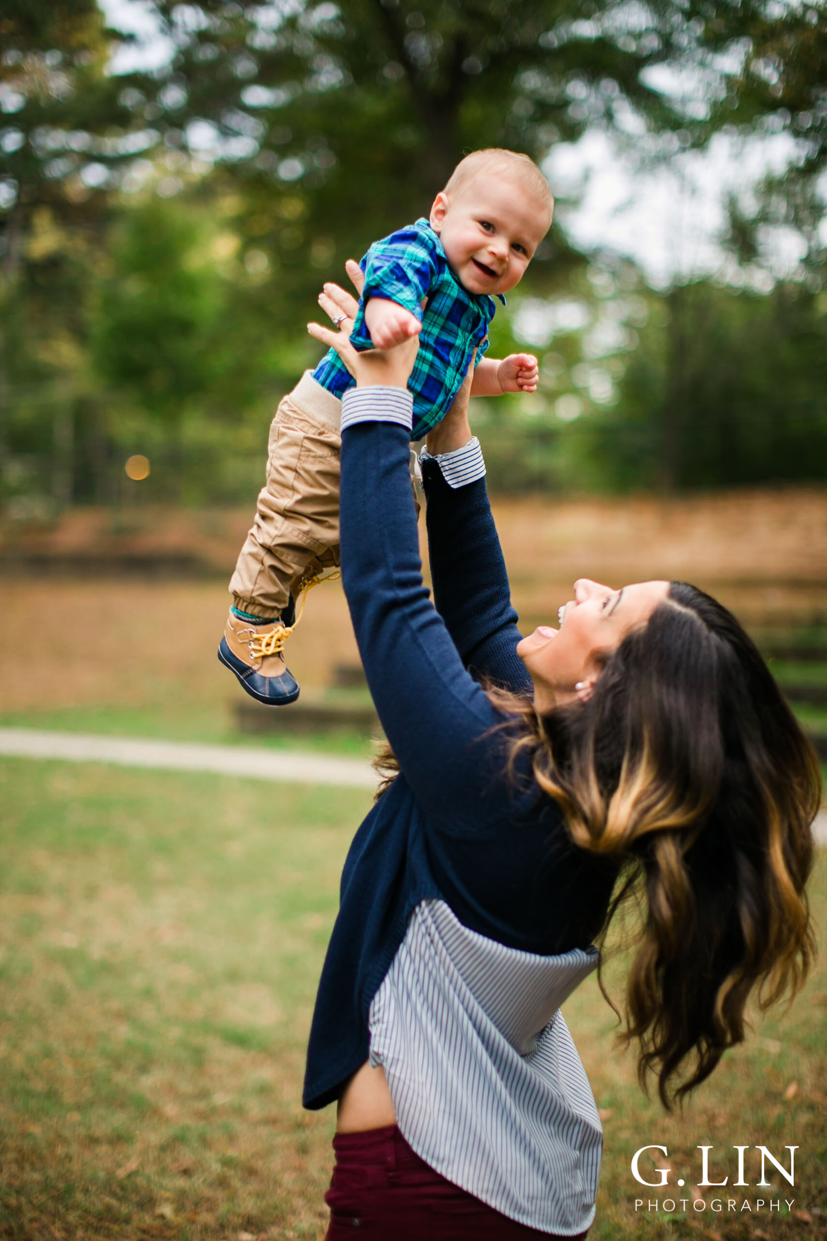 Raleigh Lifestyle Newborn Photography | G. LIn photography | Mom tossing baby boy in the air