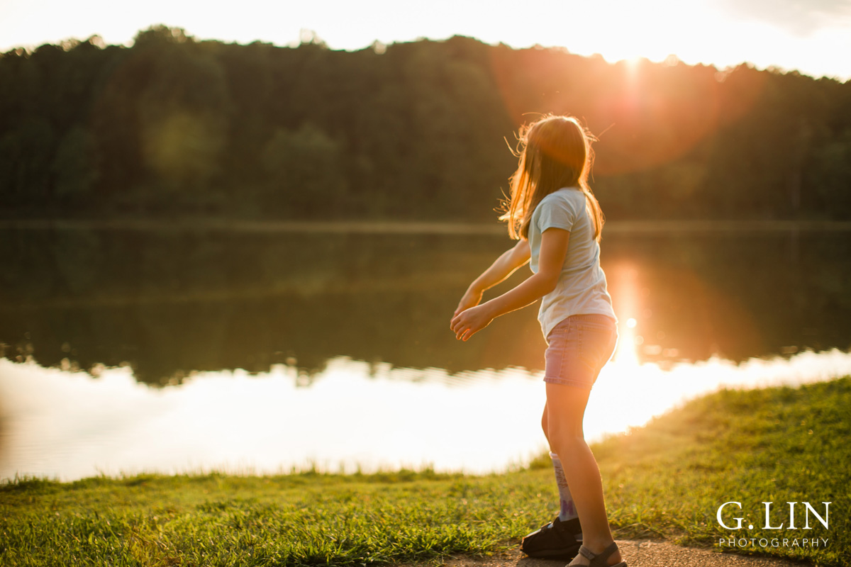 Raleigh Family Photographer | By G. Lin Photography | Girl throwing rocks in lake
