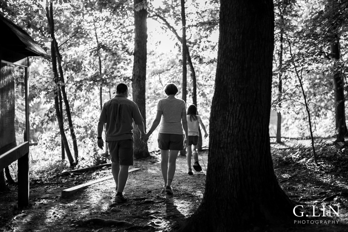 Raleigh Family Photographer | By G. Lin Photography | Black and white photo of family walking in woods