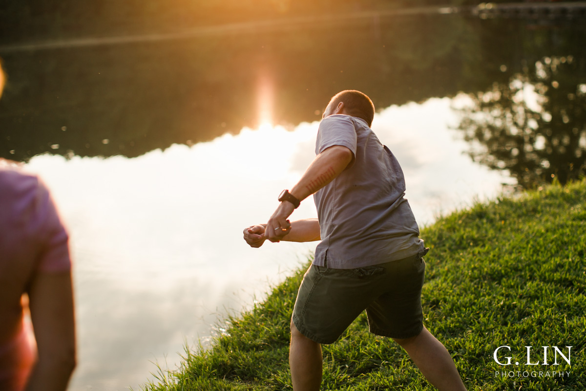 Raleigh Family Photographer | By G. Lin Photography | Dad skipping rocks on water