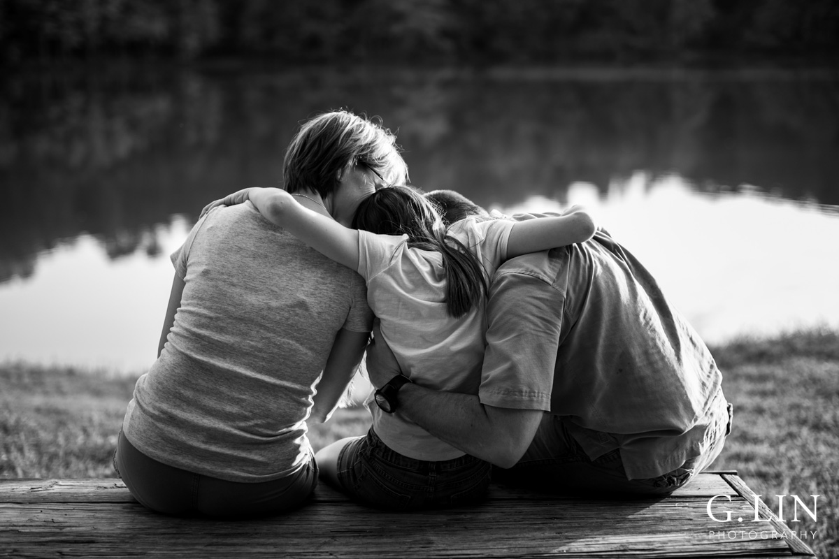 Raleigh Family Photographer | By G. Lin Photography | Beautiful black and white photo of family hugging on bench