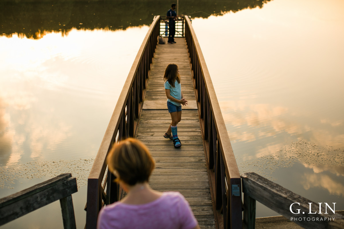 Raleigh Family Photographer | By G. Lin Photography | Creative photo of girl on bridge by the lake