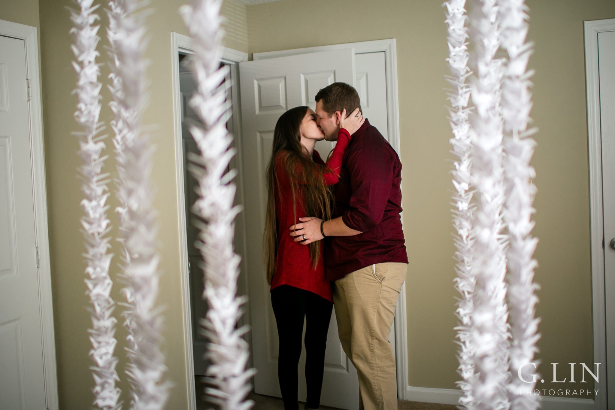Couple kissing among paper cranes | Raleigh Engagement Photographer | By G. Lin Photography