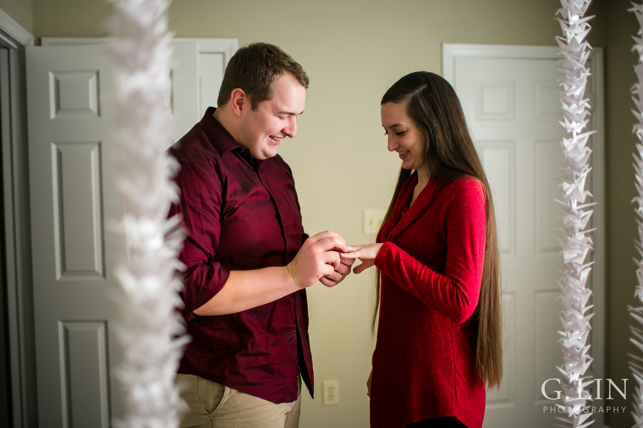 Putting ring on the girl for proposal | Raleigh Engagement Photographer | By G. Lin Photography