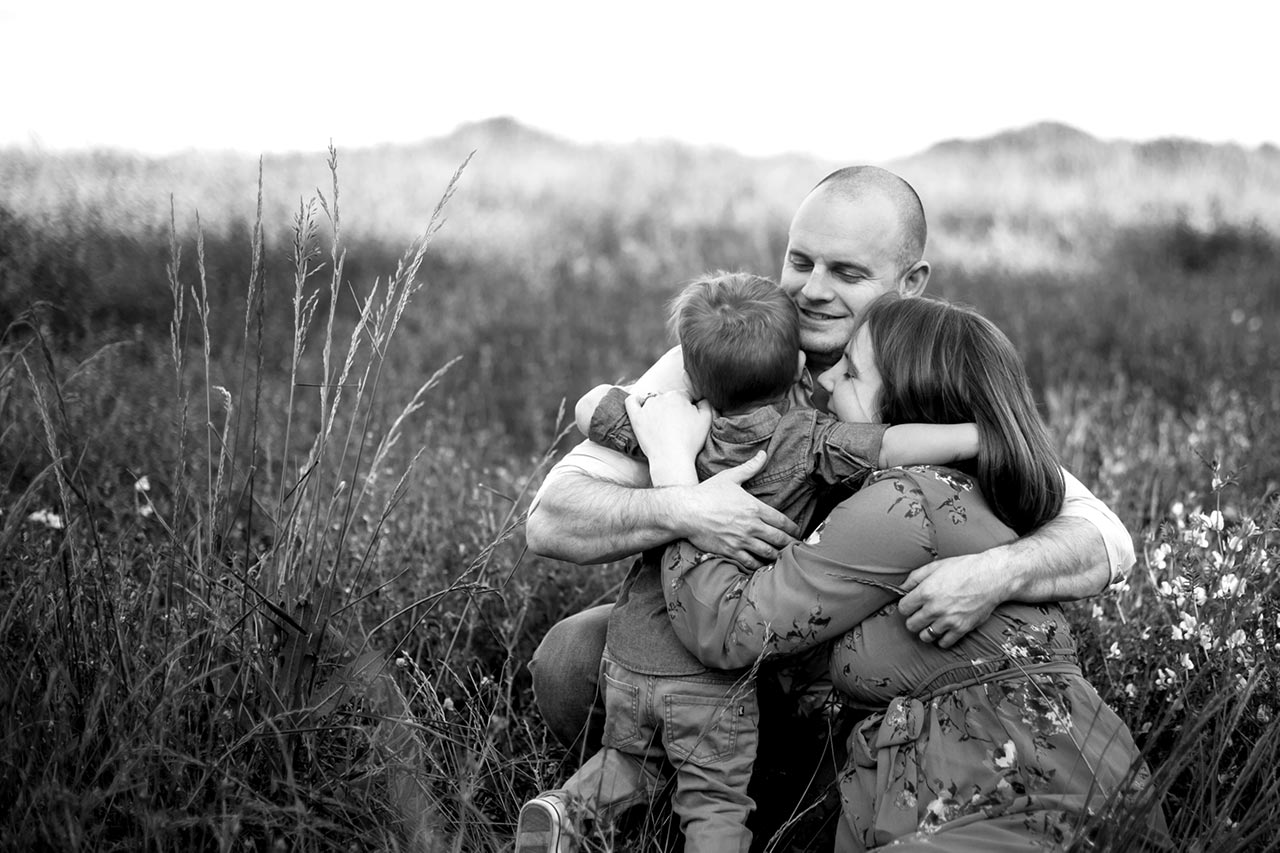 Durham Family Photographer | G. Lin Photography | Family of three hugging in the fields