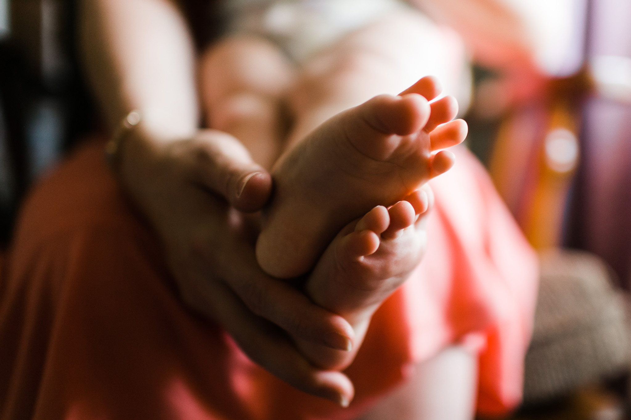 Baby feet with mother's hands | Raleigh Family Photographer | By G. Lin Photography