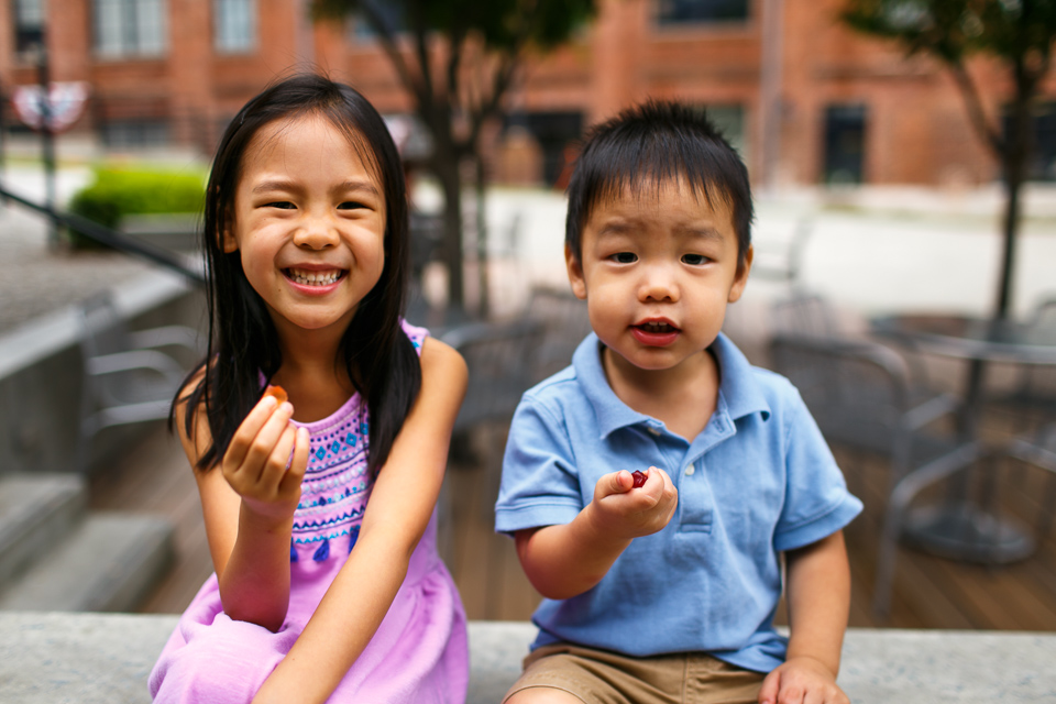 Siblings eating gummy bears | Durham Family Photographer | By G. Lin Photography