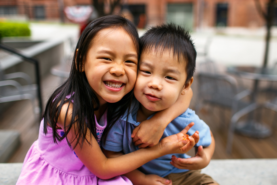 Siblings hugging on bench | Durham Family Photographer | G. Lin Photography