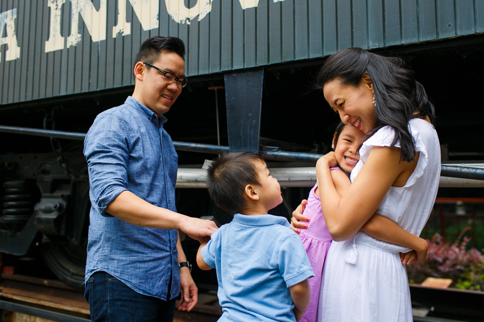 Family hugging outside in Downtown Durham | Family Photographer in Durham, NC | By G. Lin Photography