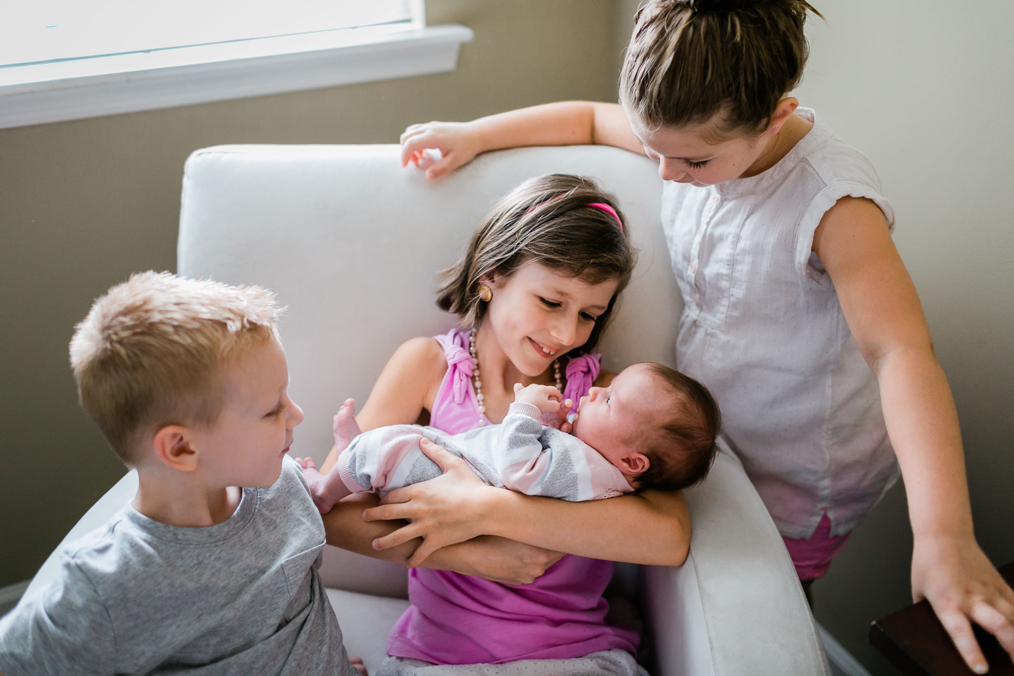 Raleigh Newborn Photographer | By G. Lin Photography | Siblings holding baby sister