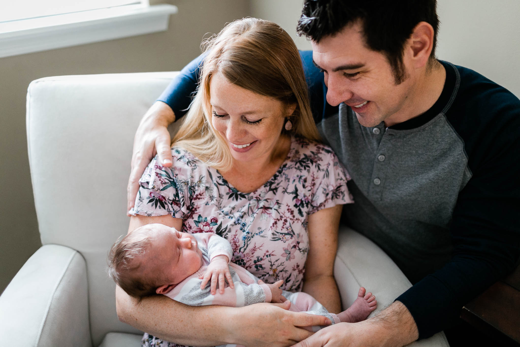 Raleigh Newborn Photographer | By G. Lin Photography | Parents sitting in chair and holding baby