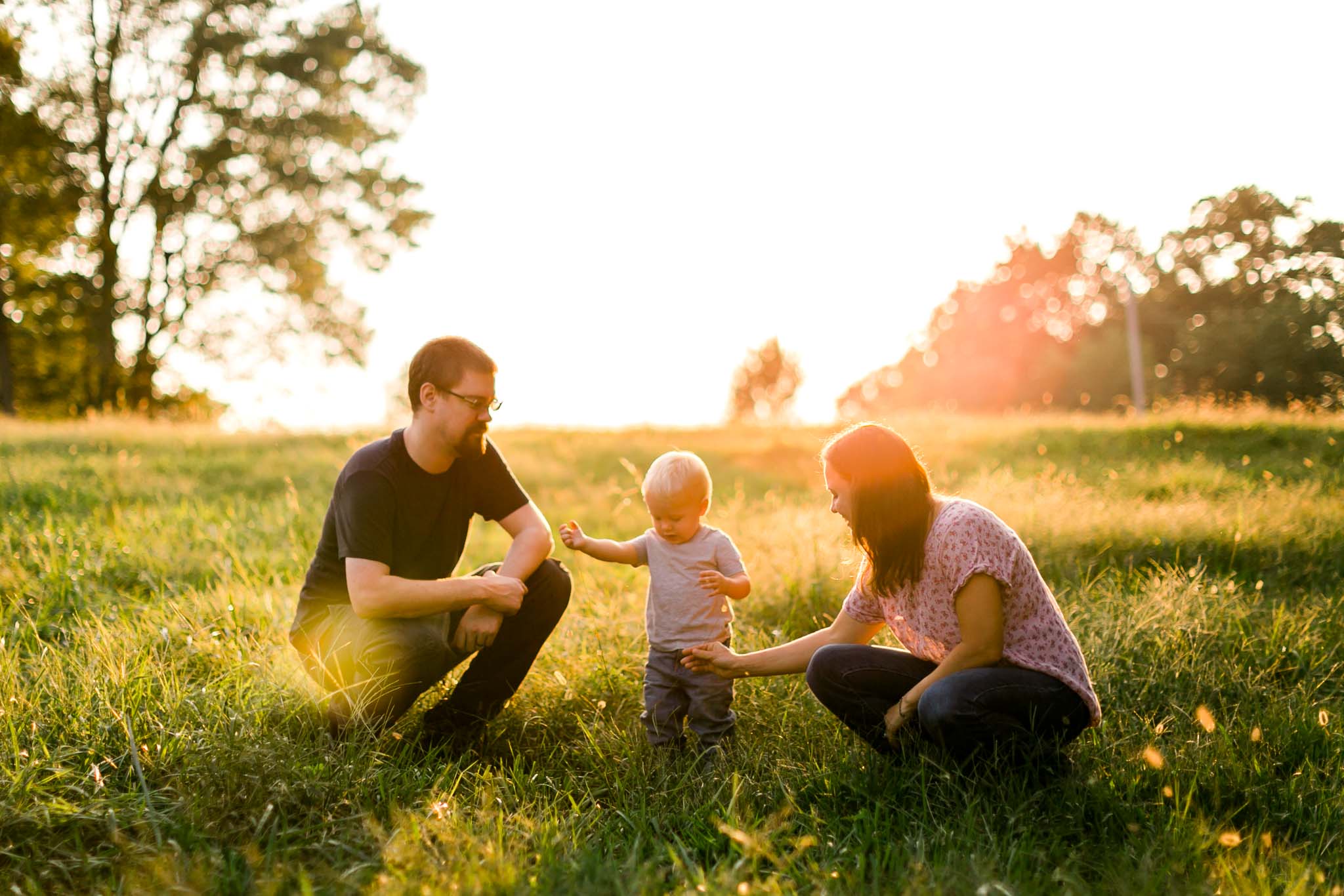 Family playing during golden hour sunset in open field | By G. Lin Photography | Rougemont Family Photographer