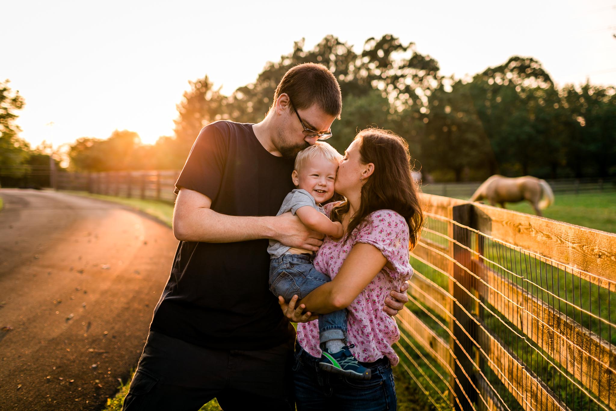 Parents kissing son on cheeks | By G. Lin Photography | Durham Rougemont Photographer