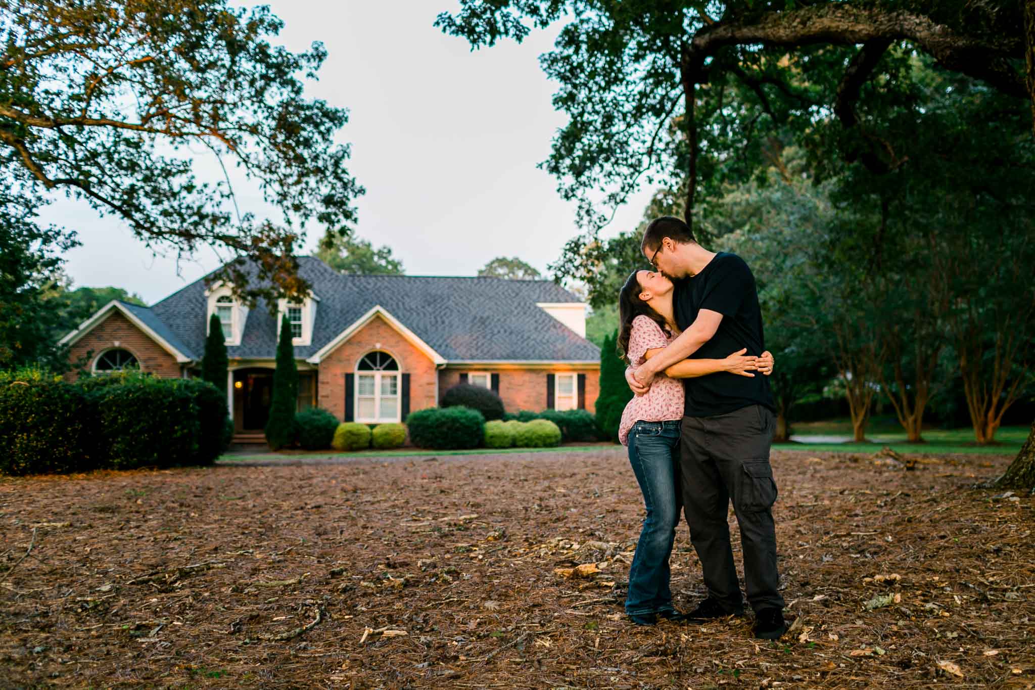 Portrait of husband and wife in front of house | By G. Lin Photography | Rougemont Family Photographer