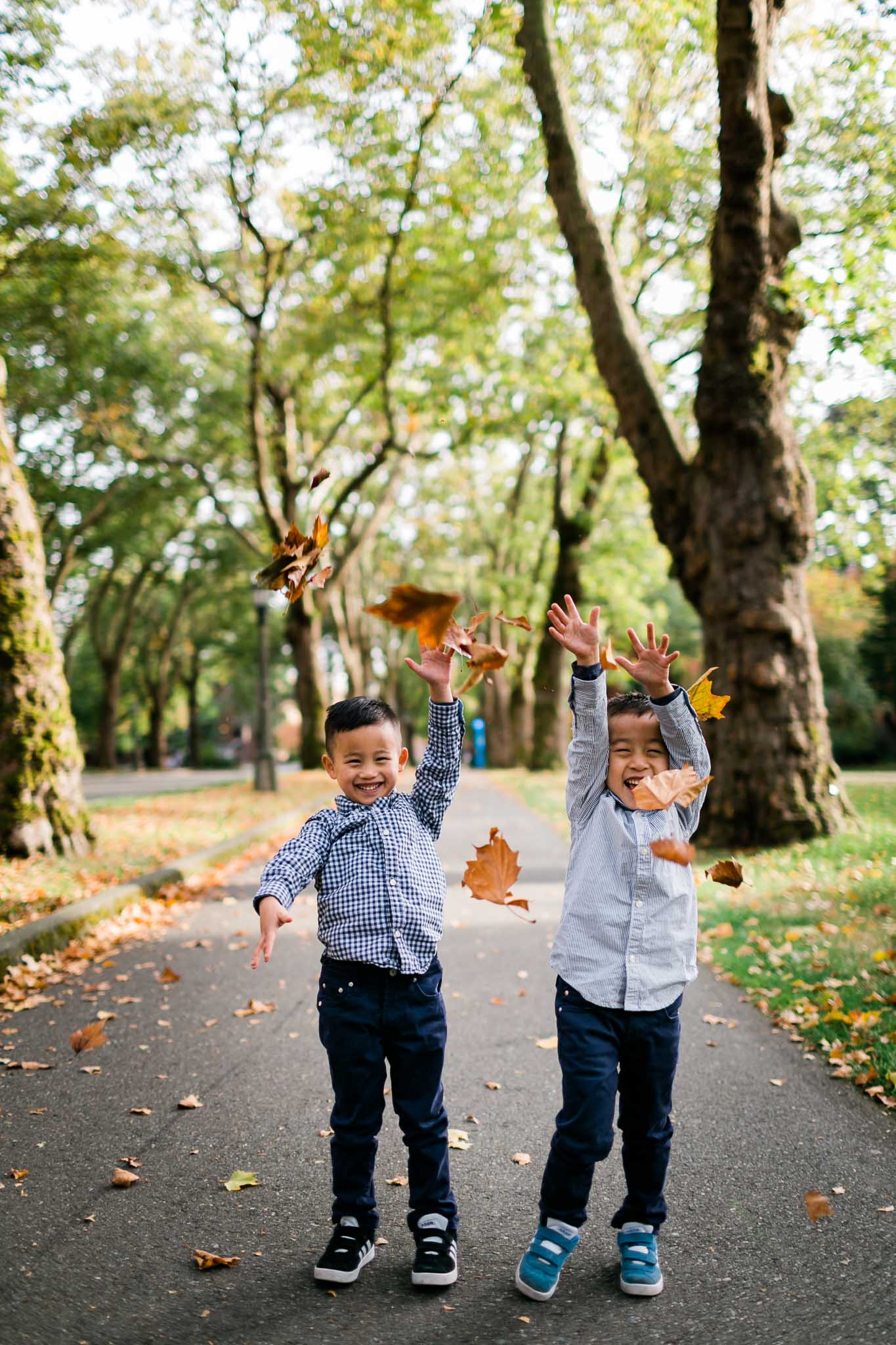 Boys laughing with leaves falling | Durham Family Photographer | By G. Lin Photography