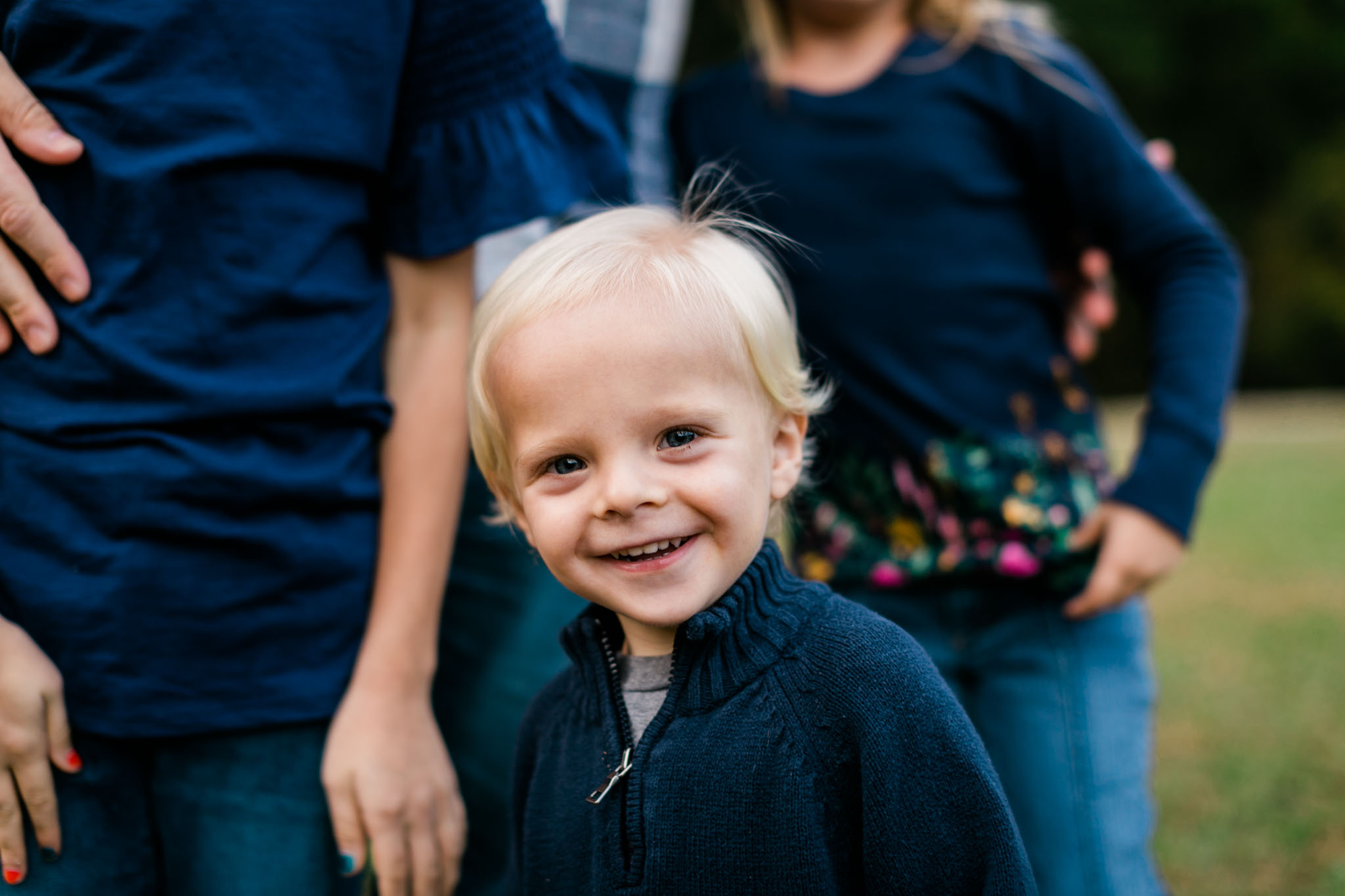 Toddler boy smiling at camera at Umstead Park | Raleigh Family Photographer | By G. Lin Photography