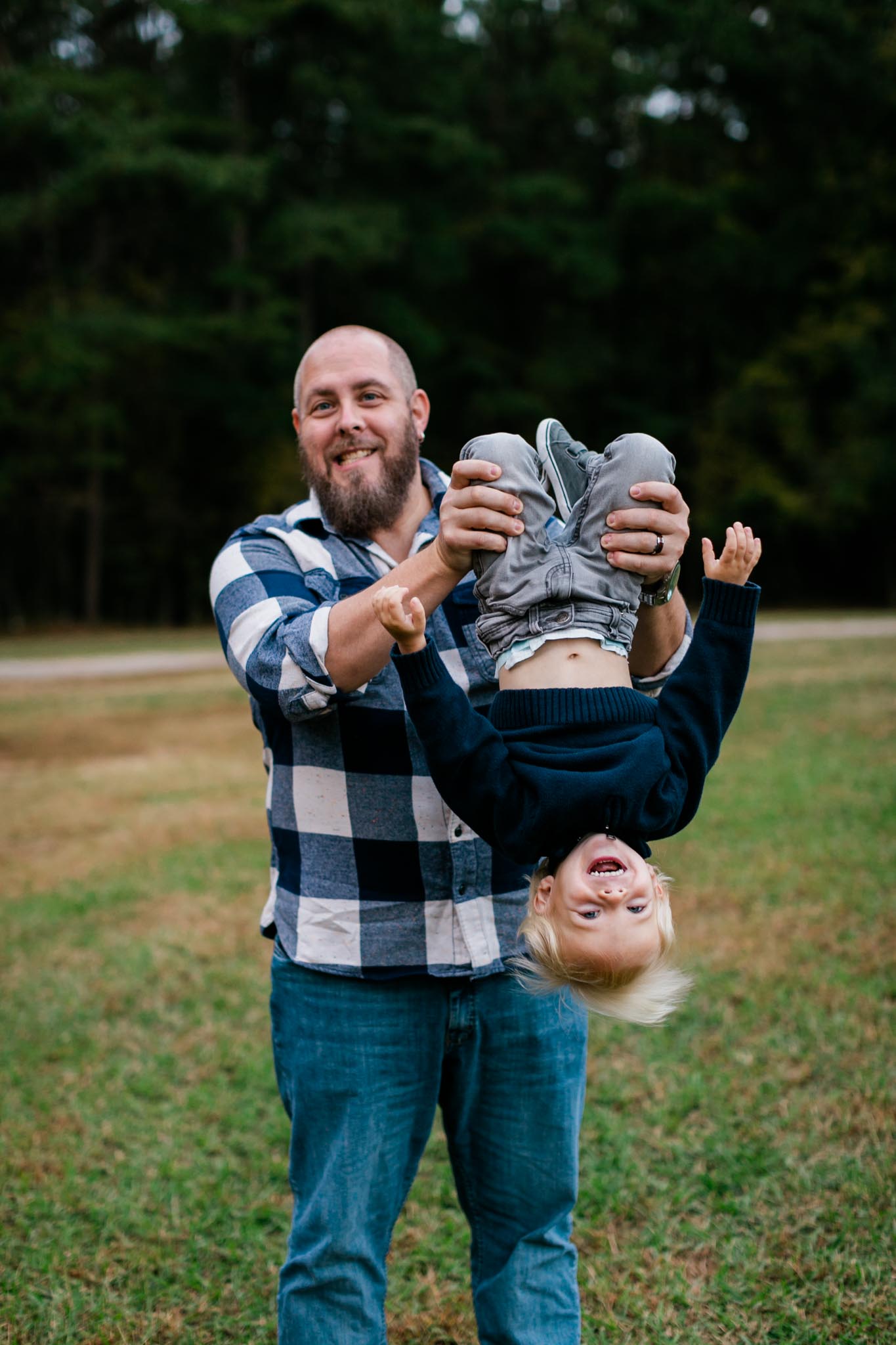 Dad holding son upside down | Raleigh Family Photographer | By G. Lin Photography