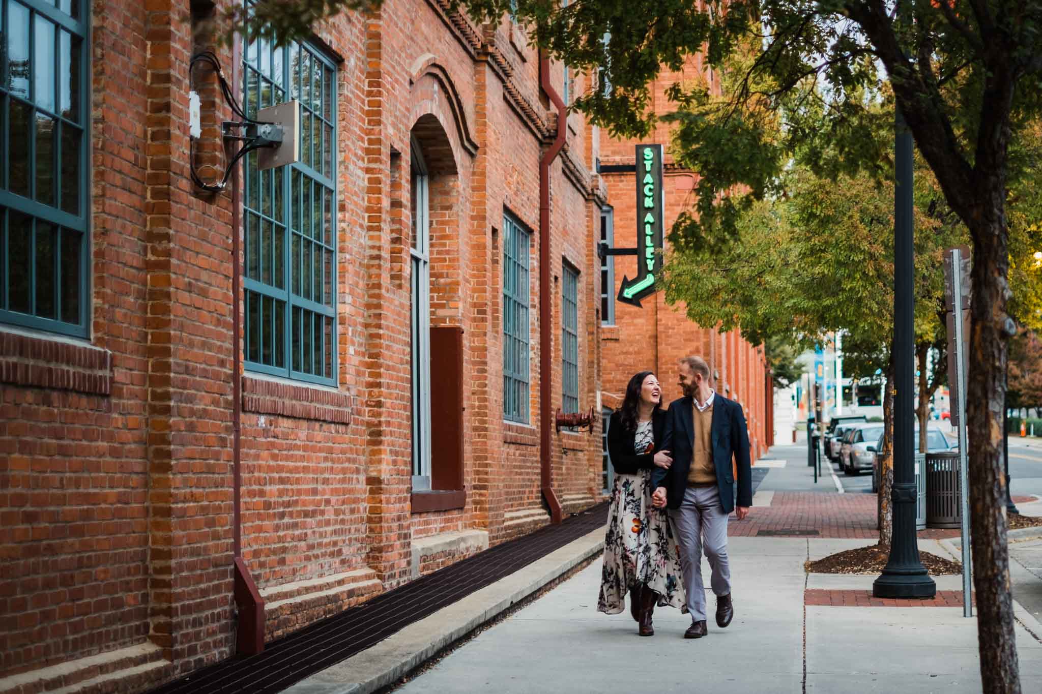 Couple walking down sidewalk at American Tobacco Campus | Durham Photographer | By G. Lin Photography