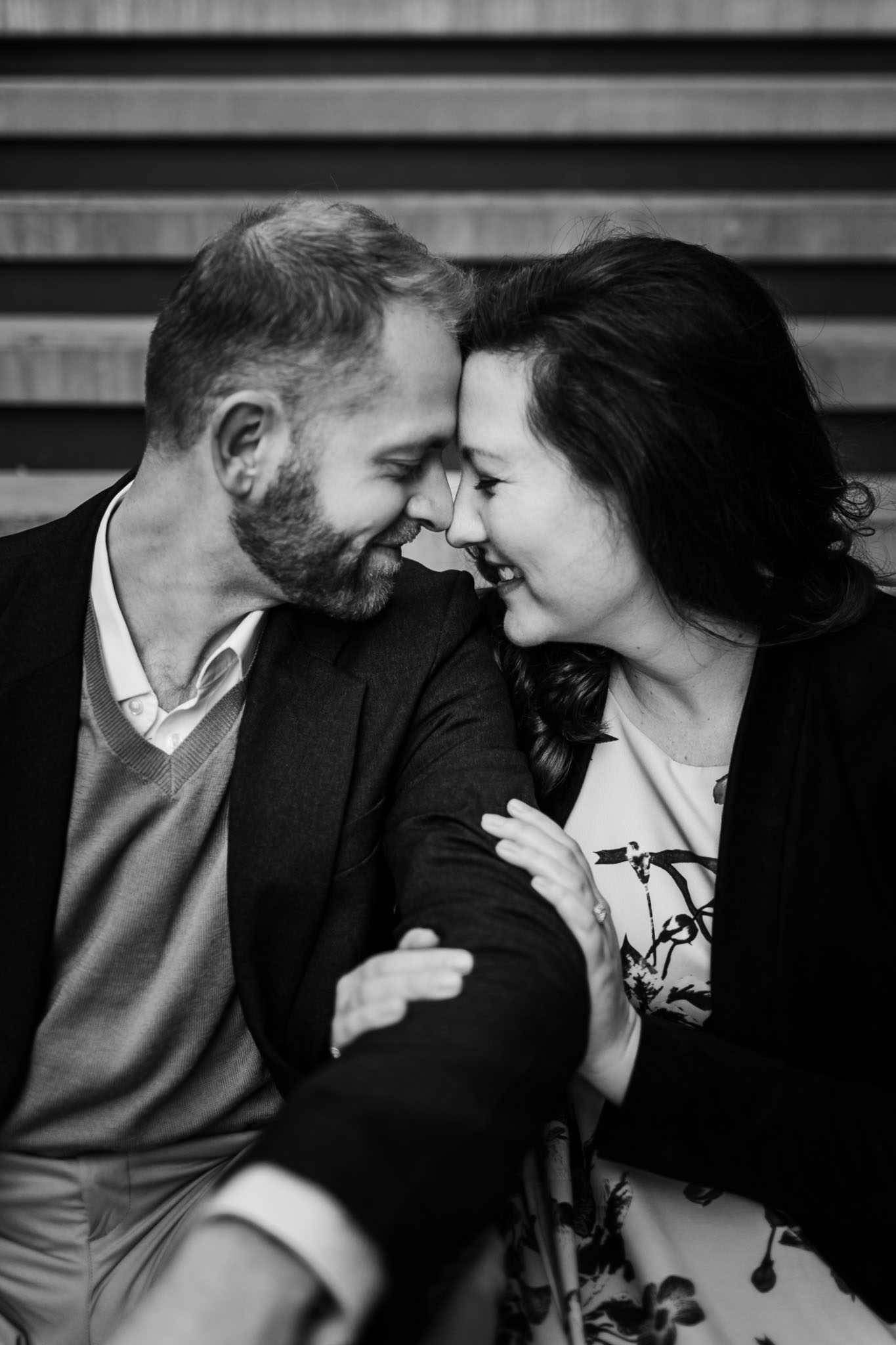 Black and white photo of couple sitting on steps | Durham Photographer | By G. Lin Photography