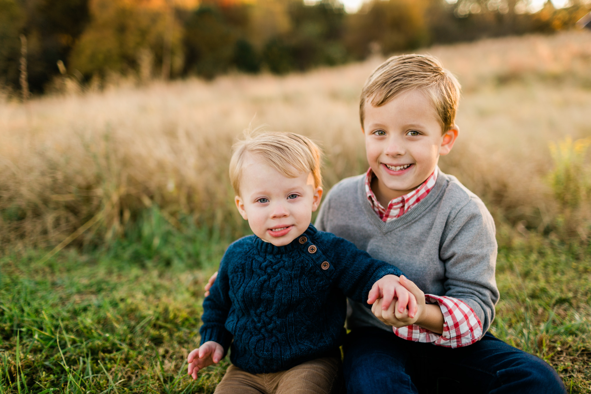 Cute photo of brothers sitting on grass | Raleigh Family Photographer | By G. Lin Photography