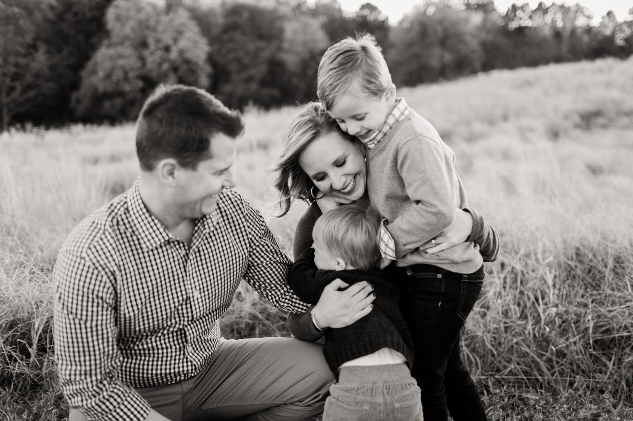 Black and white photo of family smiling outside  at NCMA | Raleigh Family Photographer | By G. Lin Photography
