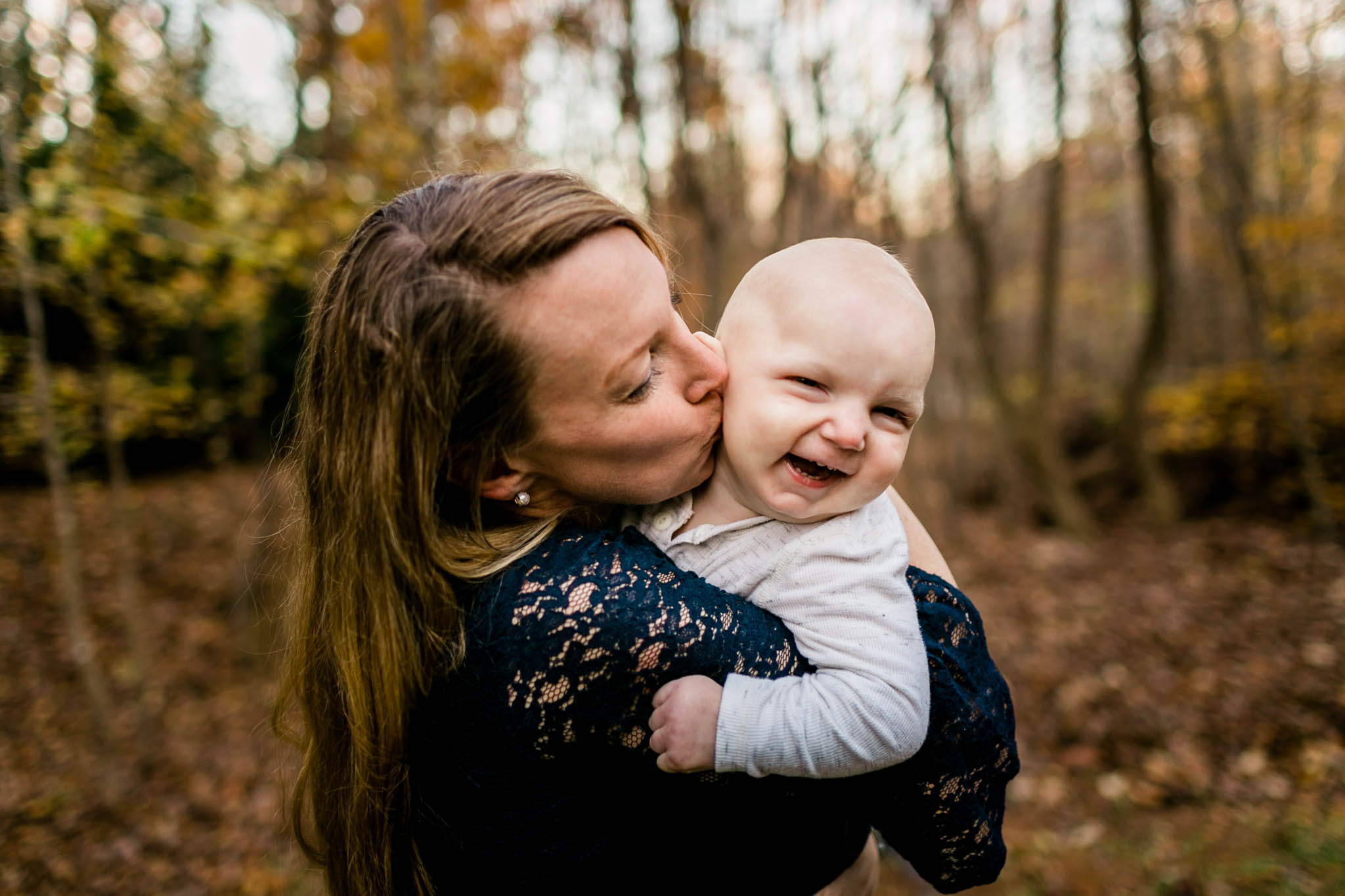 Mom kissing son on cheek | By G. Lin Photography | Durham Family Photographer