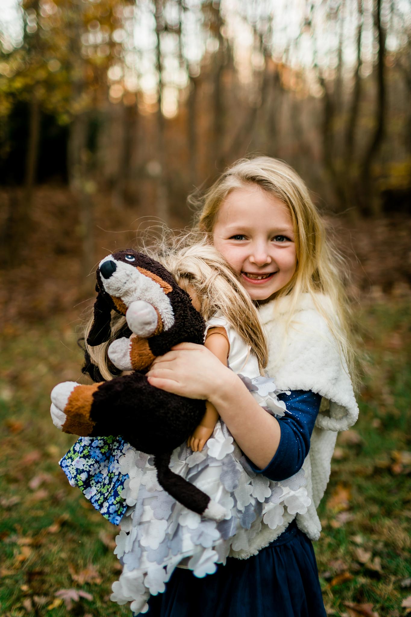 Young girl holding stuffed animals | By G. Lin Photography | Raleigh Family Photographer