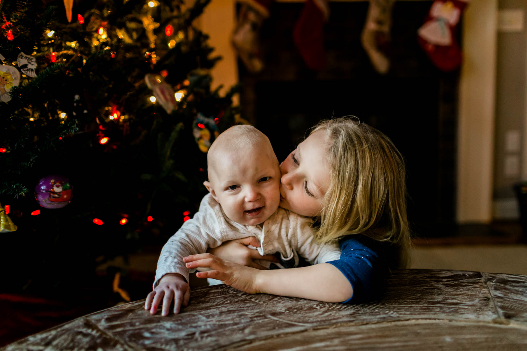 Sister kissing little brother on cheek | By G. Lin Photography | Durham Family Photographer