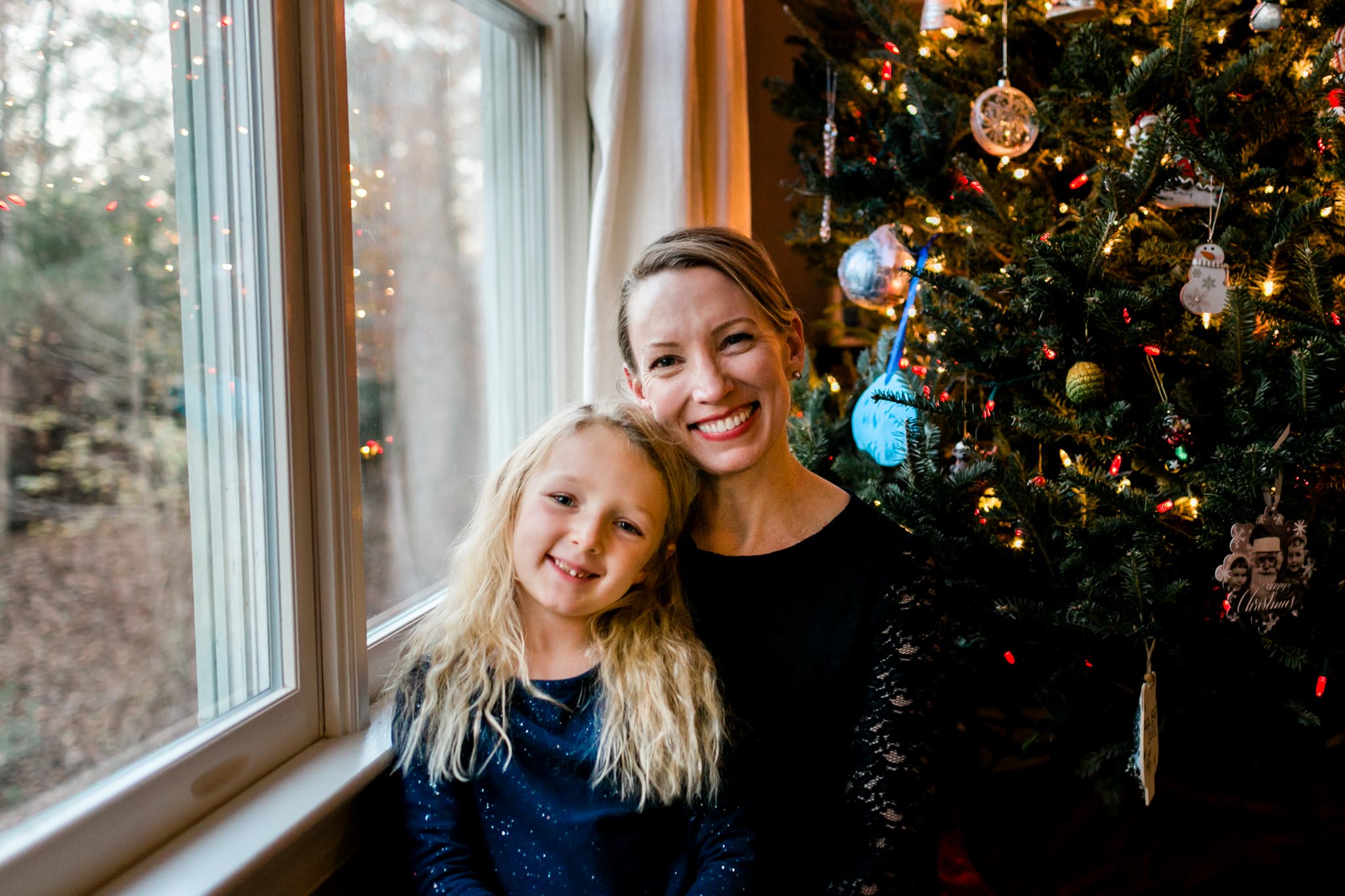 Mother and daughter sitting by Christmas tree | By G. Lin Photography | Durham Photographer