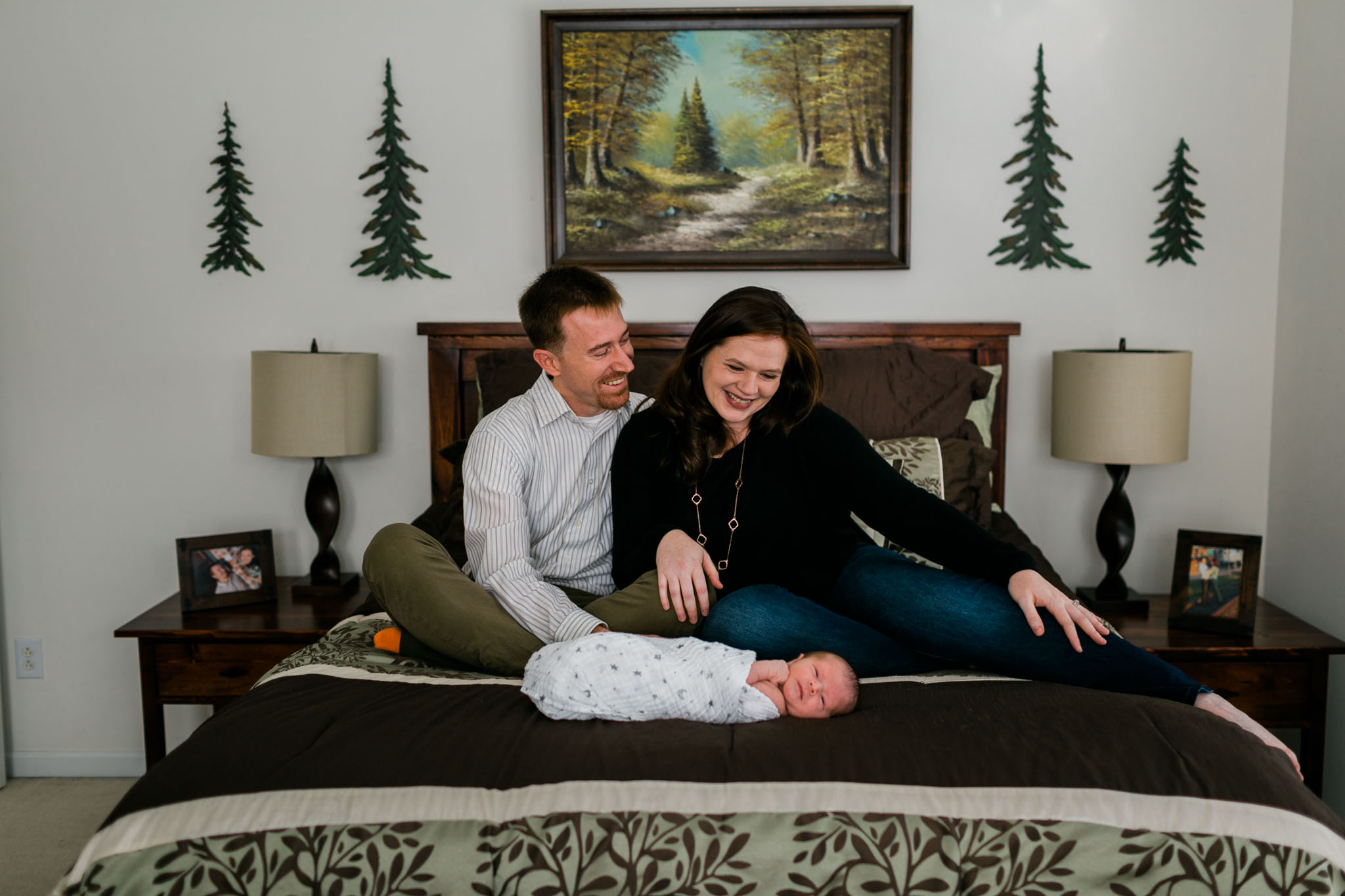 Couple sitting on bed with baby | Raleigh Newborn Photographer | By G. Lin Photography