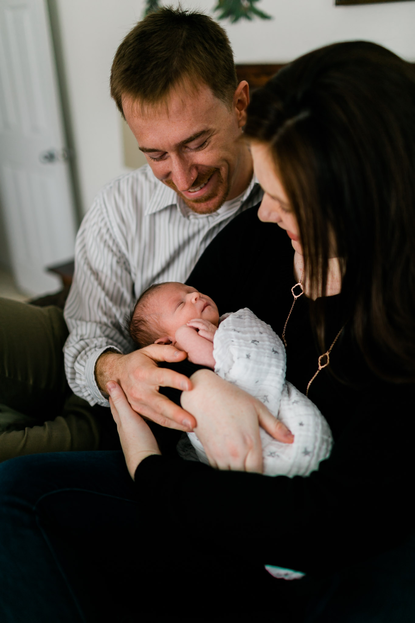 Parents holding baby girl at home | Durham Newborn Photographer | By G. Lin Photography