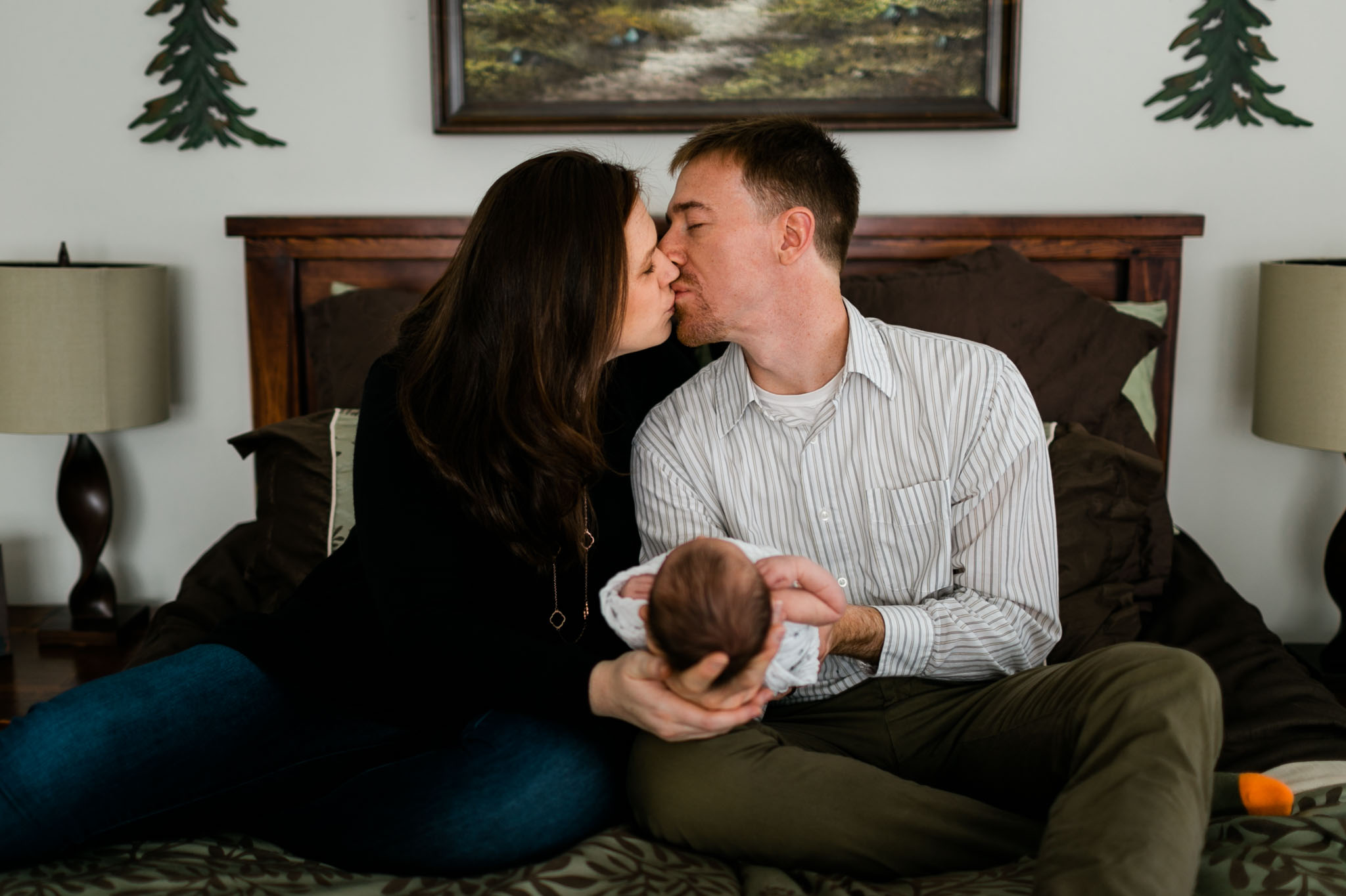 Parents holding baby and kissing | Durham Newborn Photographer | By G. Lin Photography