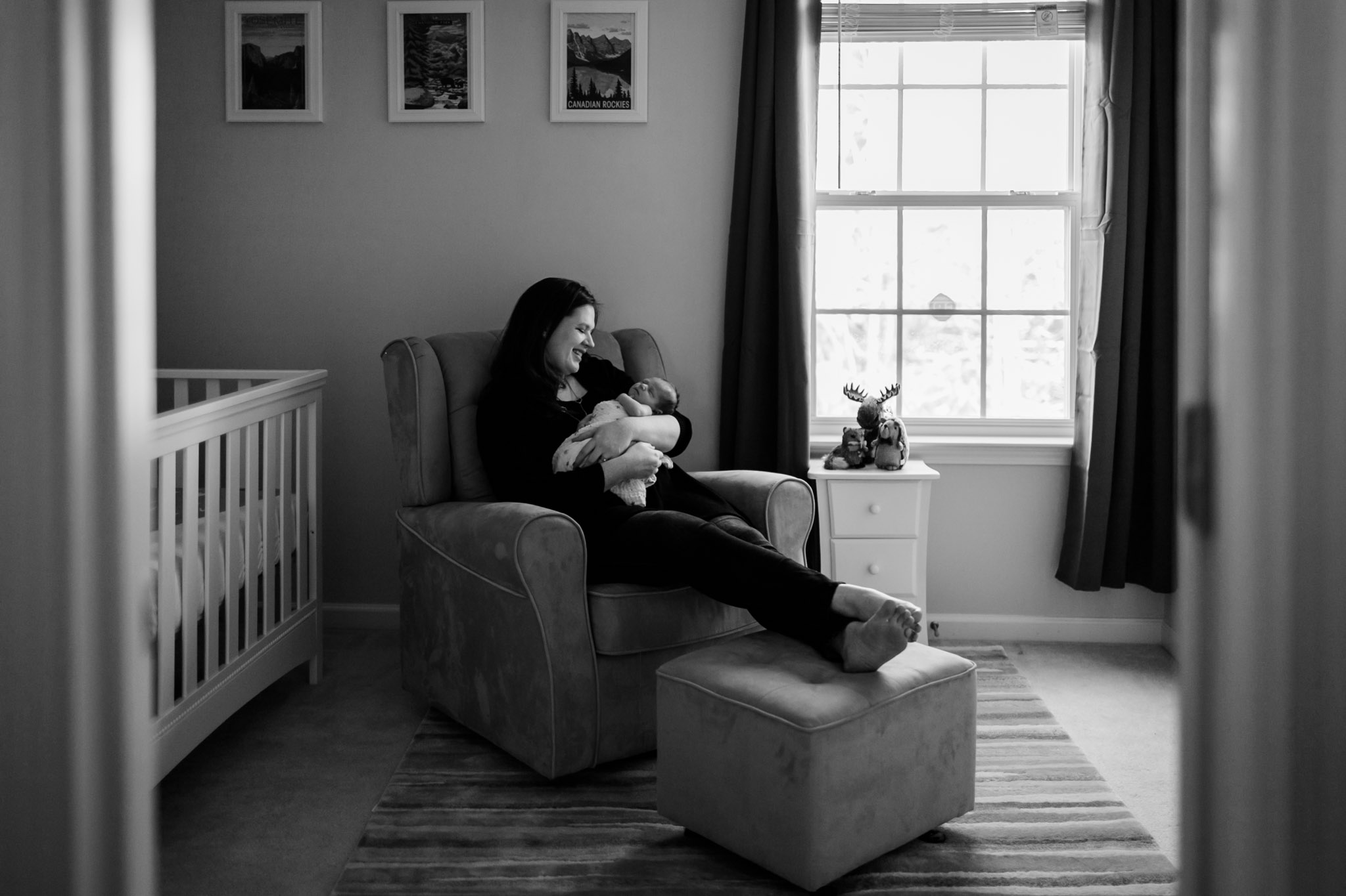Mom sitting with baby in nursery at home | Durham Newborn Photographer | By G. Lin Photography