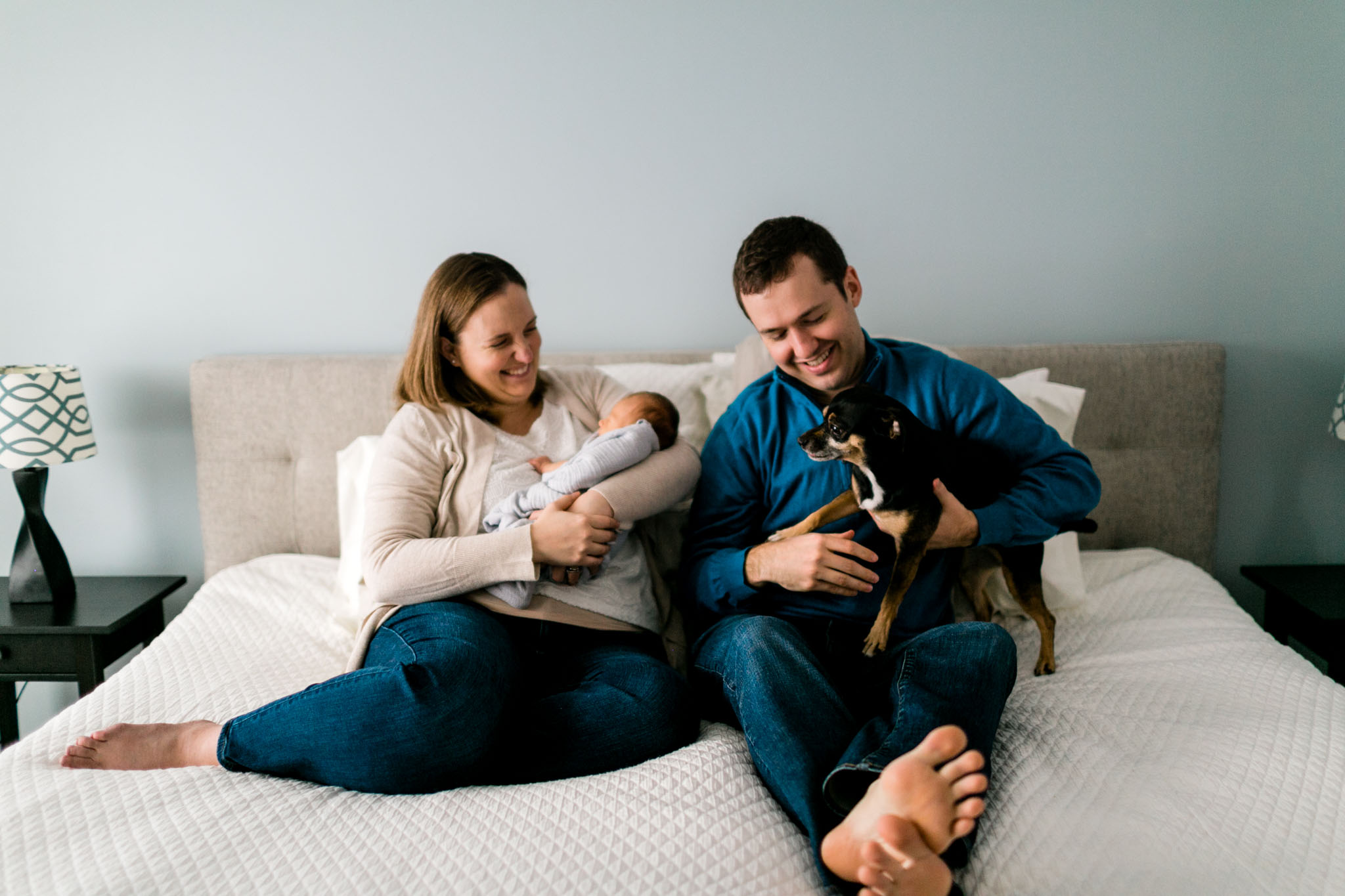 Durham Newborn Photographer | By G. Lin Photography | Candid photo of family sitting on bed at home